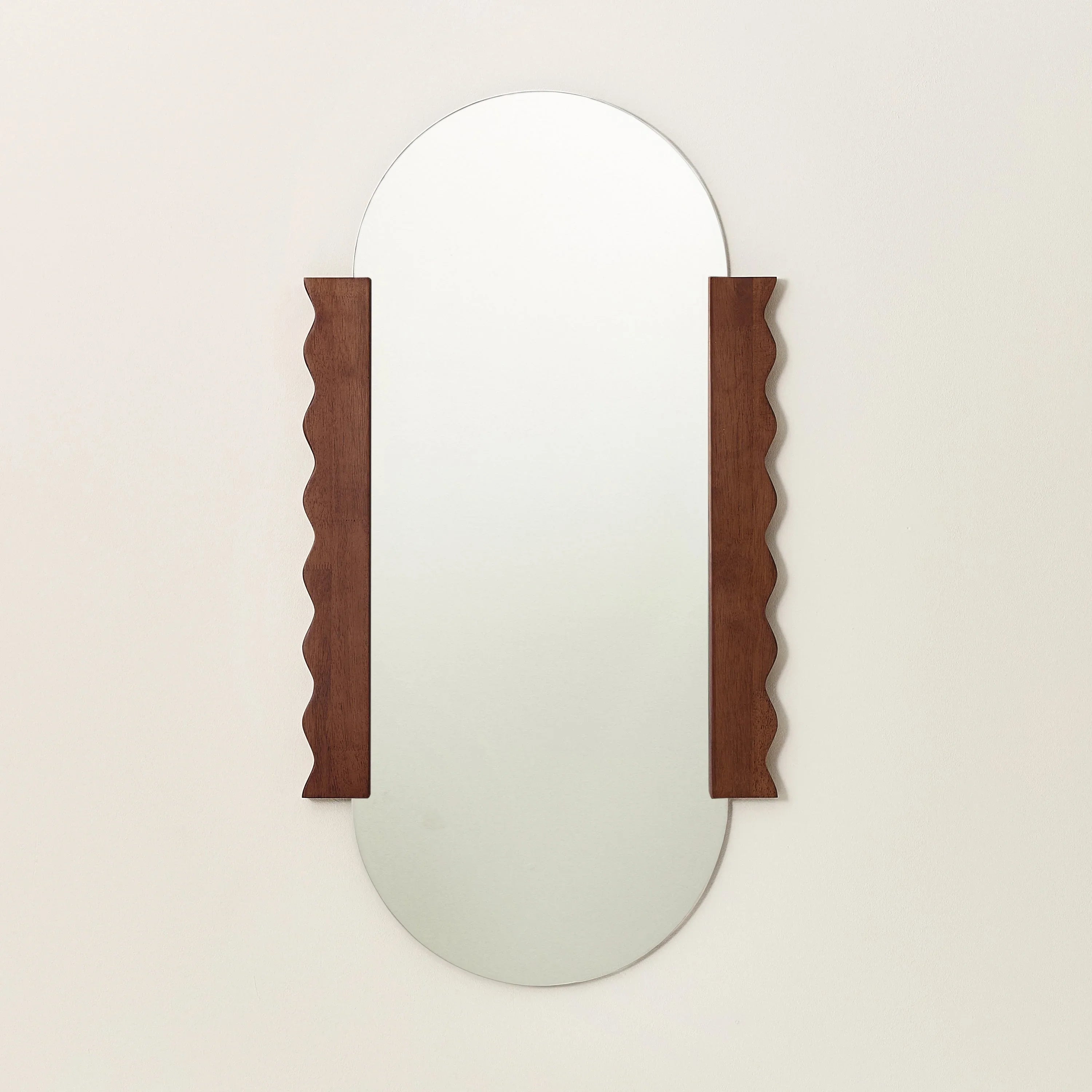 Dowel Jones oval wall mirror with wavy edged walnut wood frame and glass, modern design