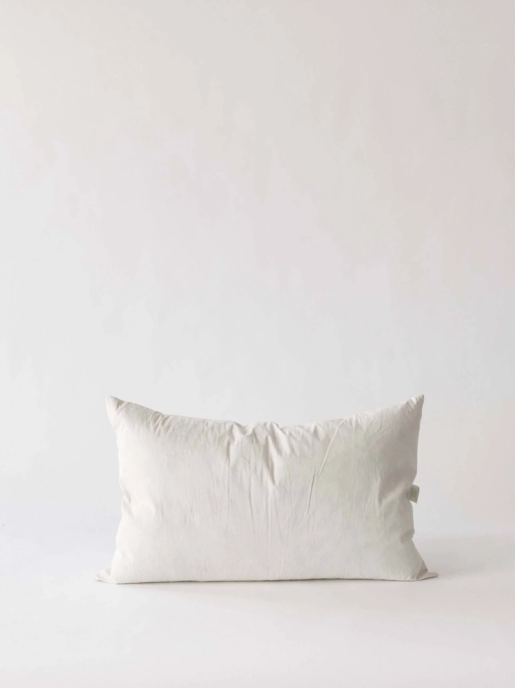 nontoxic essentials white rectangular pillow in organic cotton on white background
