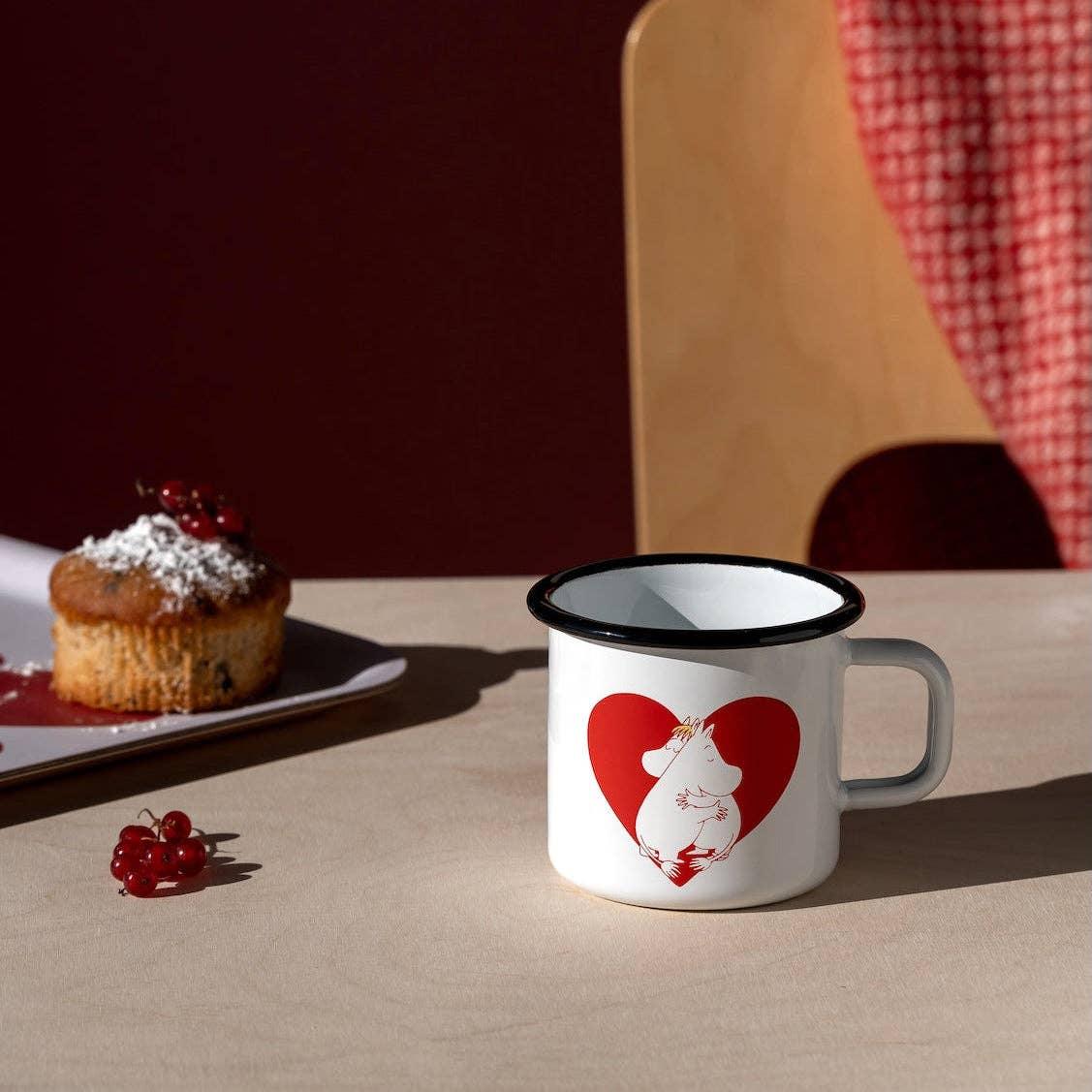 Moomin white enamel mug with red heart design on table, premium Nordic kitchenware