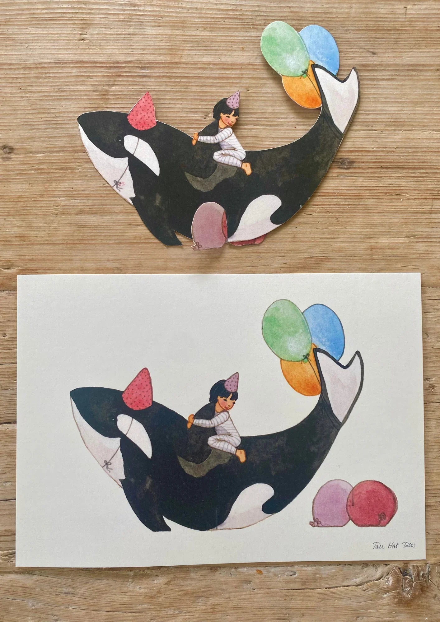 Tall Hat Tales art print, paper cutout of child on party orca with balloons, colourful illustration