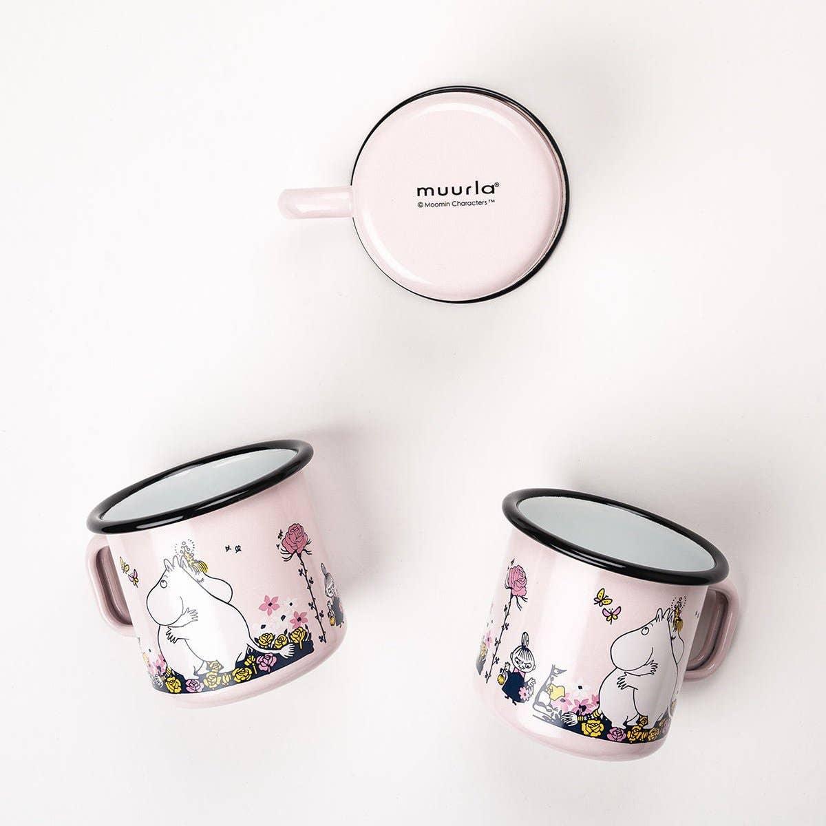 Muurla pink enamel mugs with Moomin design and floral pattern on white background