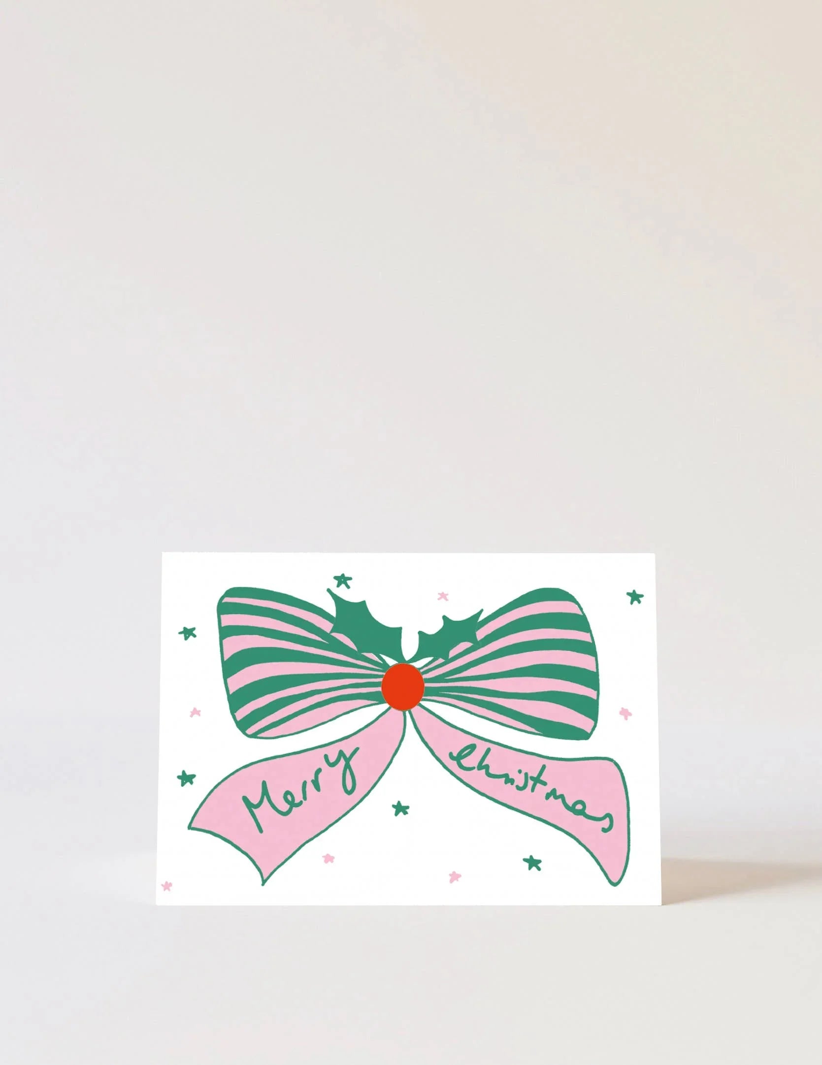 Carolyn Suzuki Christmas card with green and pink bow on white card stock
