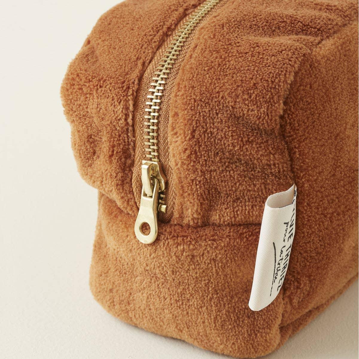 Luv Lou brown sherpa pouch with gold zipper and branded side tag