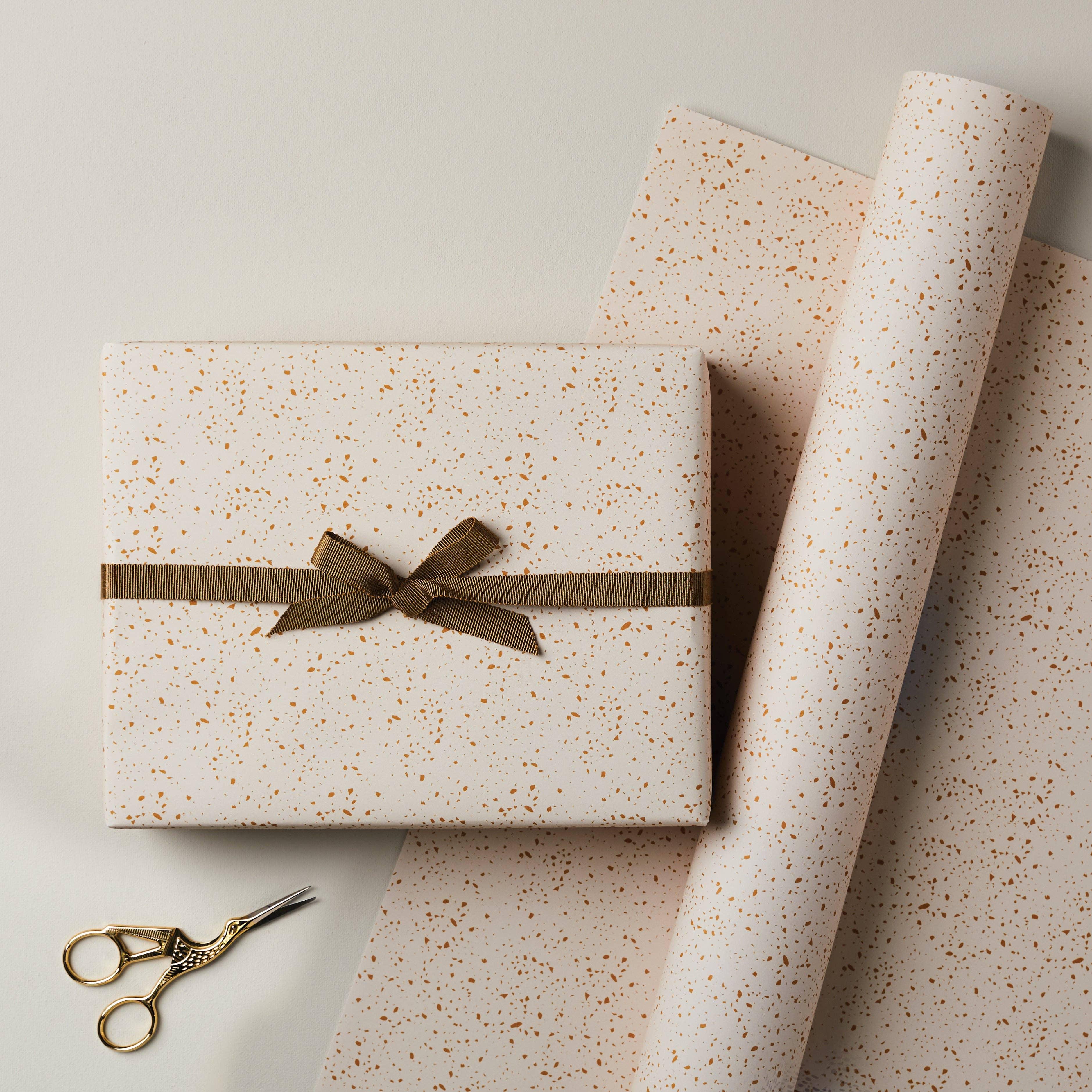 Katie Leamon luxury gift wrap, cream paper with gold speckle pattern and brown ribbon