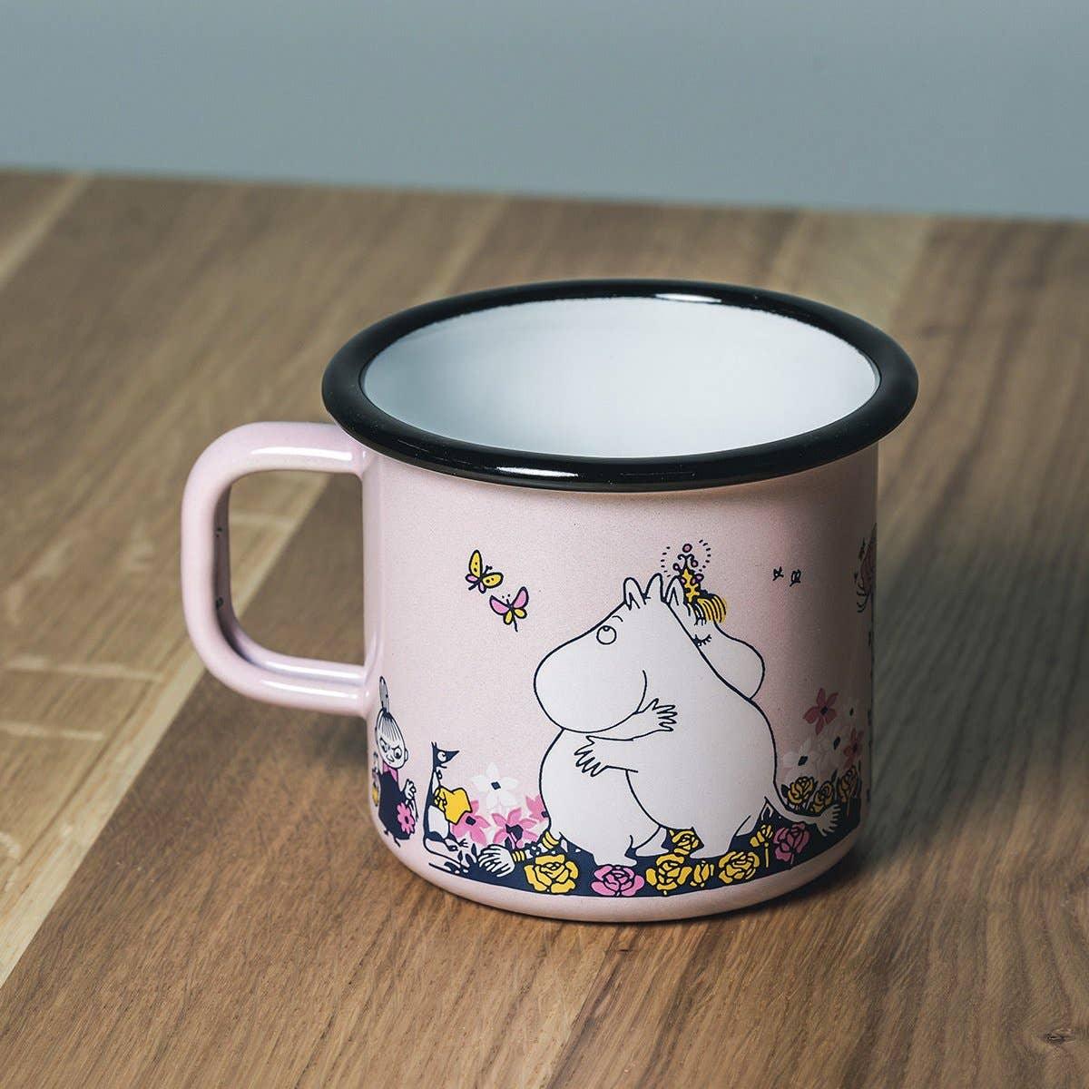 Muurla pink enamel mug with Moomin characters and floral print on wooden table