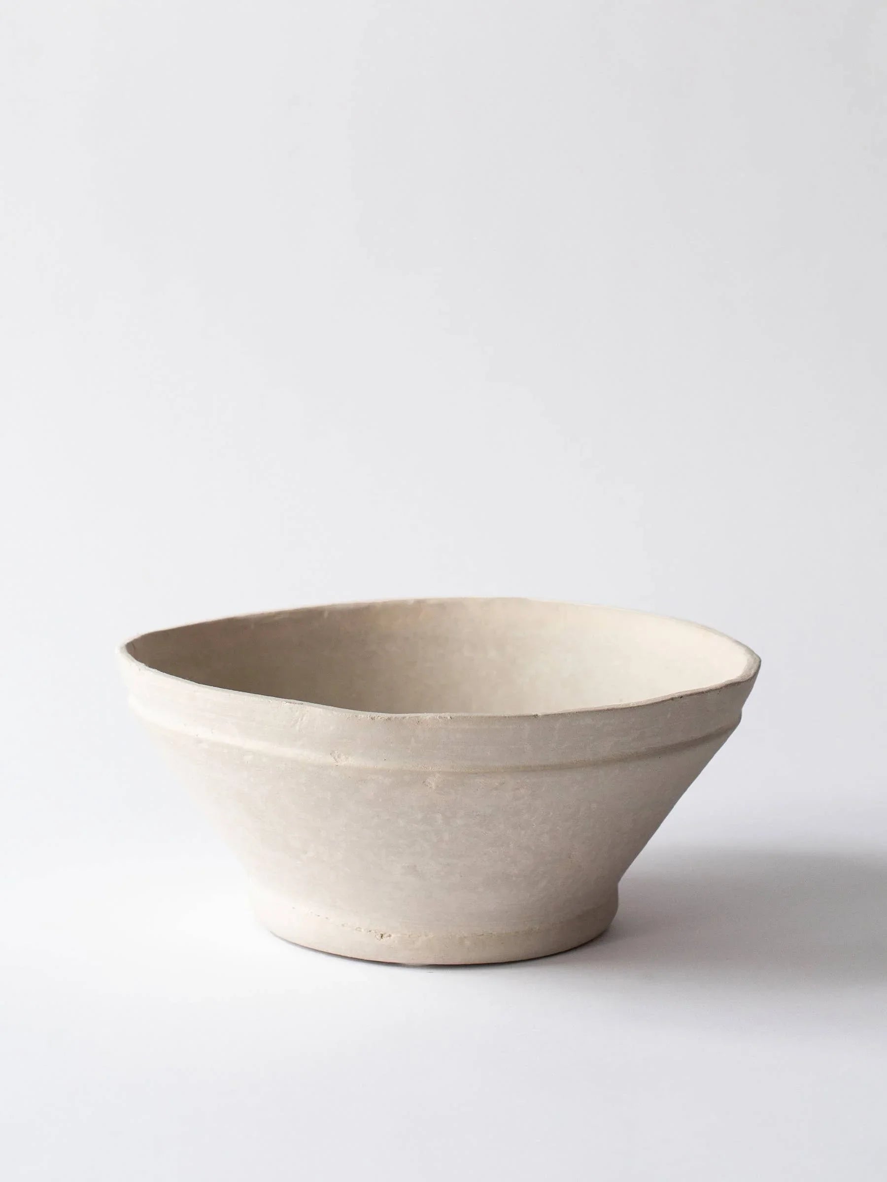 Hasami Porcelain beige ceramic bowl, minimalist Japanese stoneware on white background