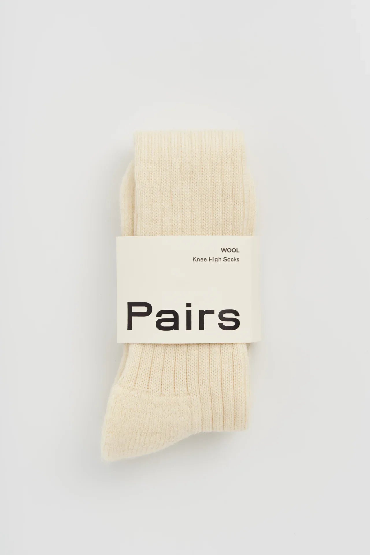 Pairs wool knee high socks in cream color, ribbed texture, premium minimalist packaging