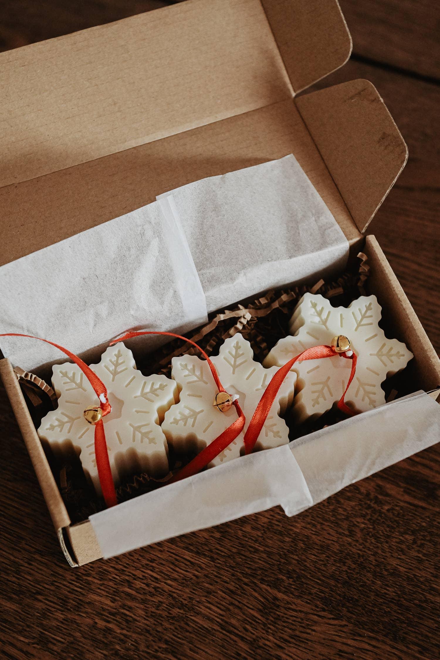 Snowflake-shaped white wax ornaments with red ribbon by Northlore, boxed gift set