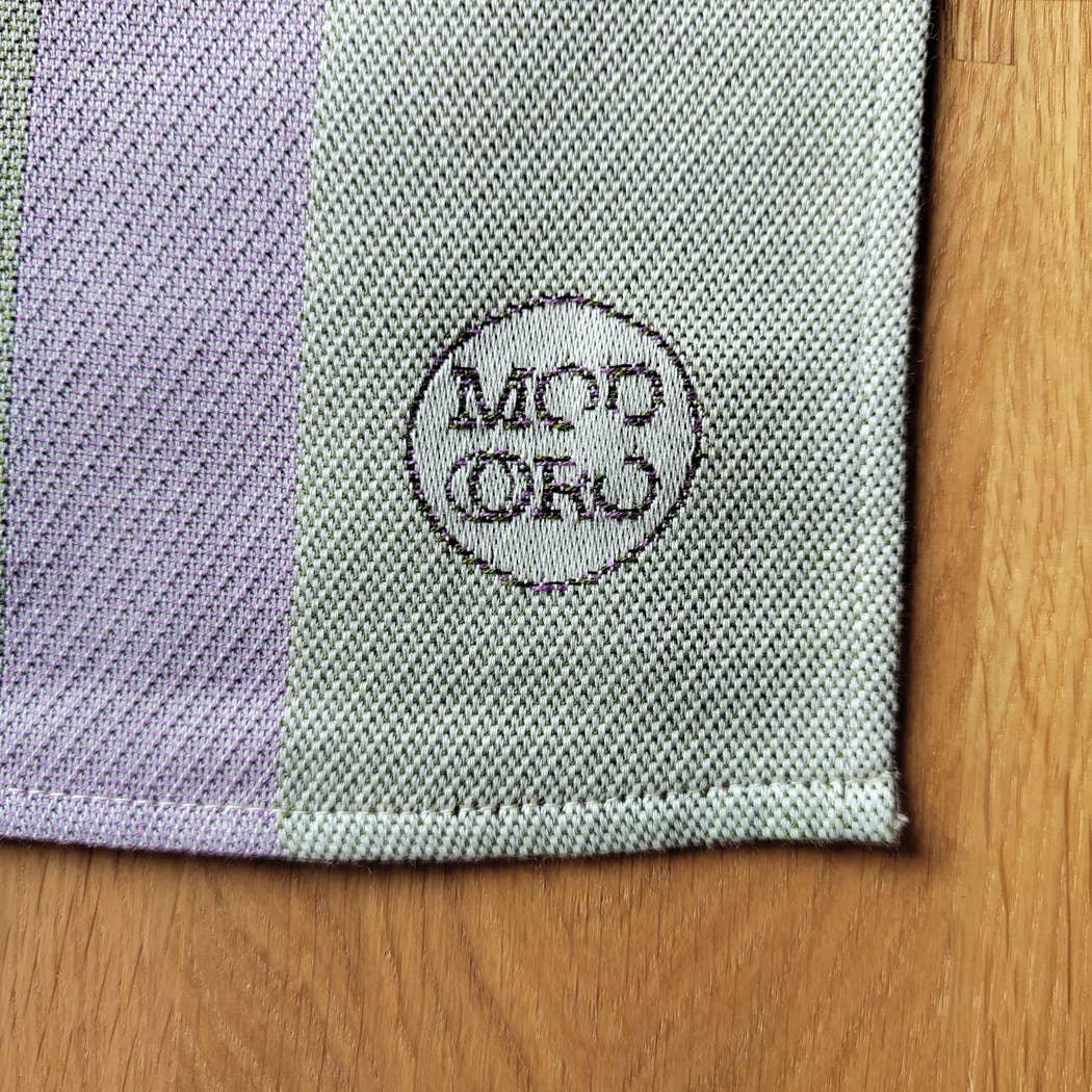 MOD ORG cotton woven placemat in pastel green and lavender on wood surface