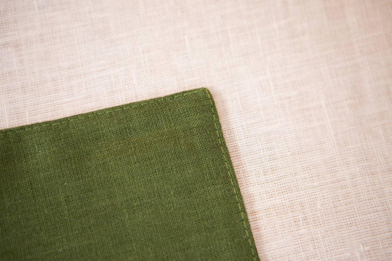 Linen Tales olive green linen napkin corner on beige linen tablecloth