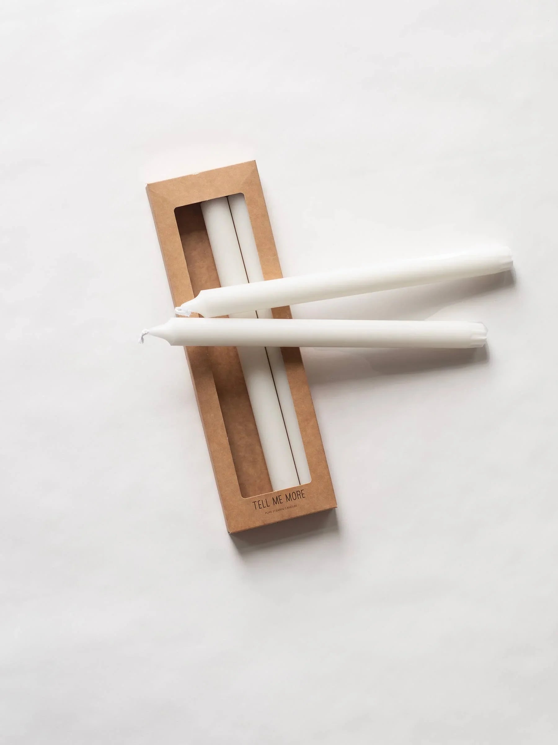 Tell Me More white taper candles in brown box, premium wax, minimalist packaging