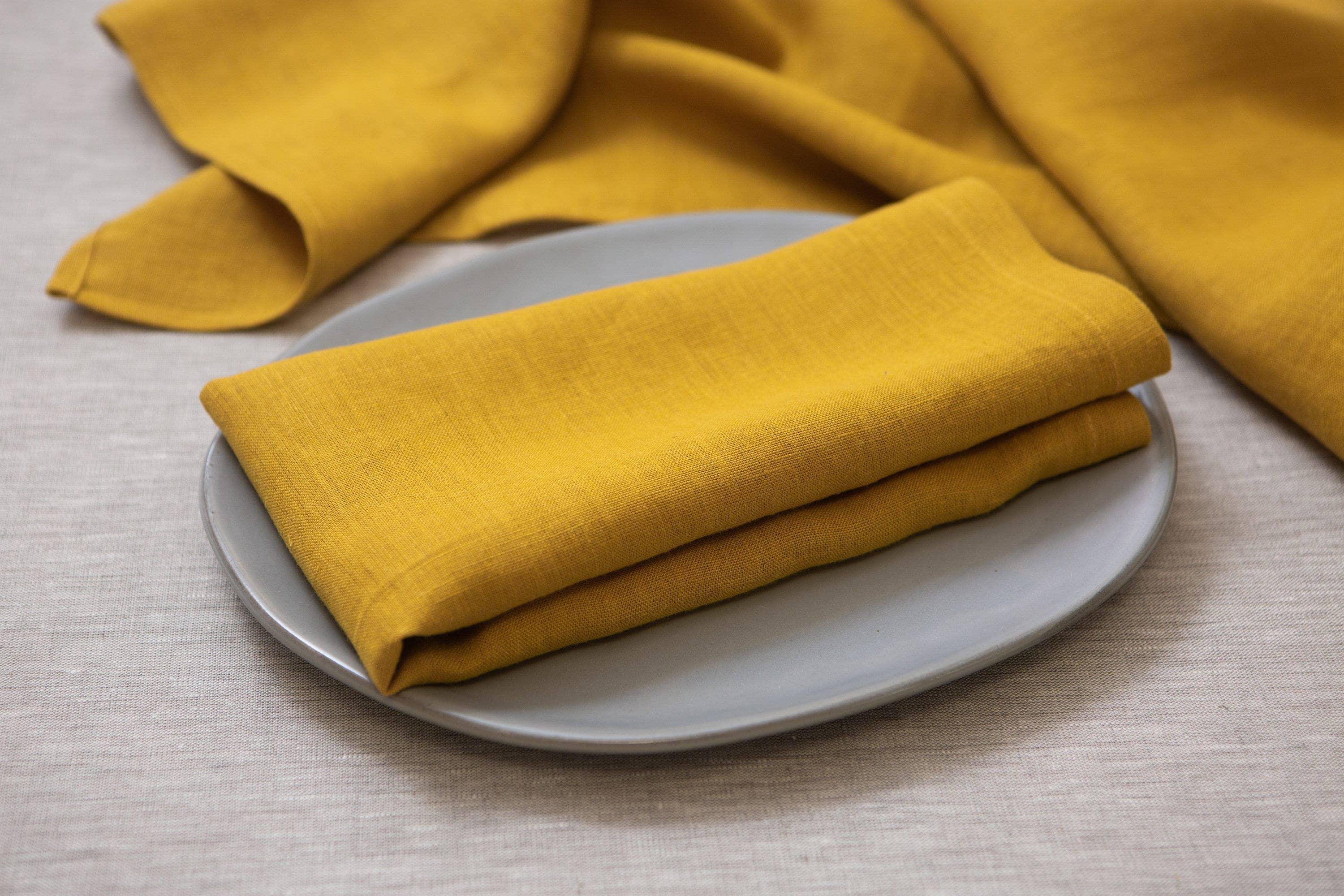 Linen Tales mustard yellow linen napkin on ceramic plate, premium table linen
