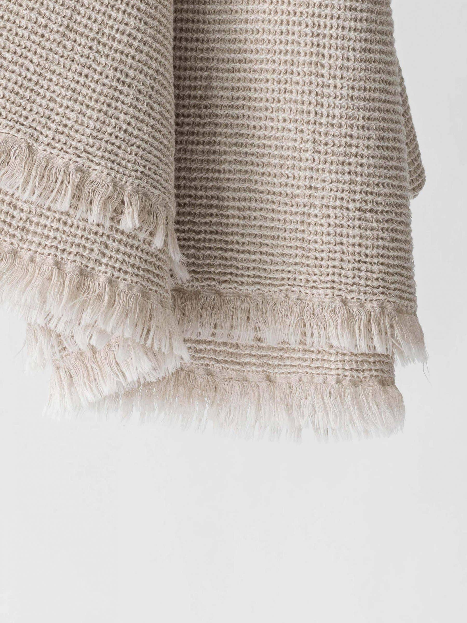 Citta beige cotton woven throw blanket with fringed edges