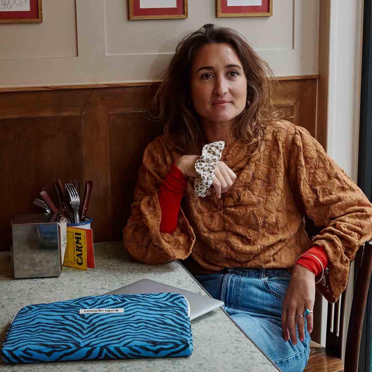 Rose In April blue zebra print laptop sleeve on table, fabric, premium stylish accessory