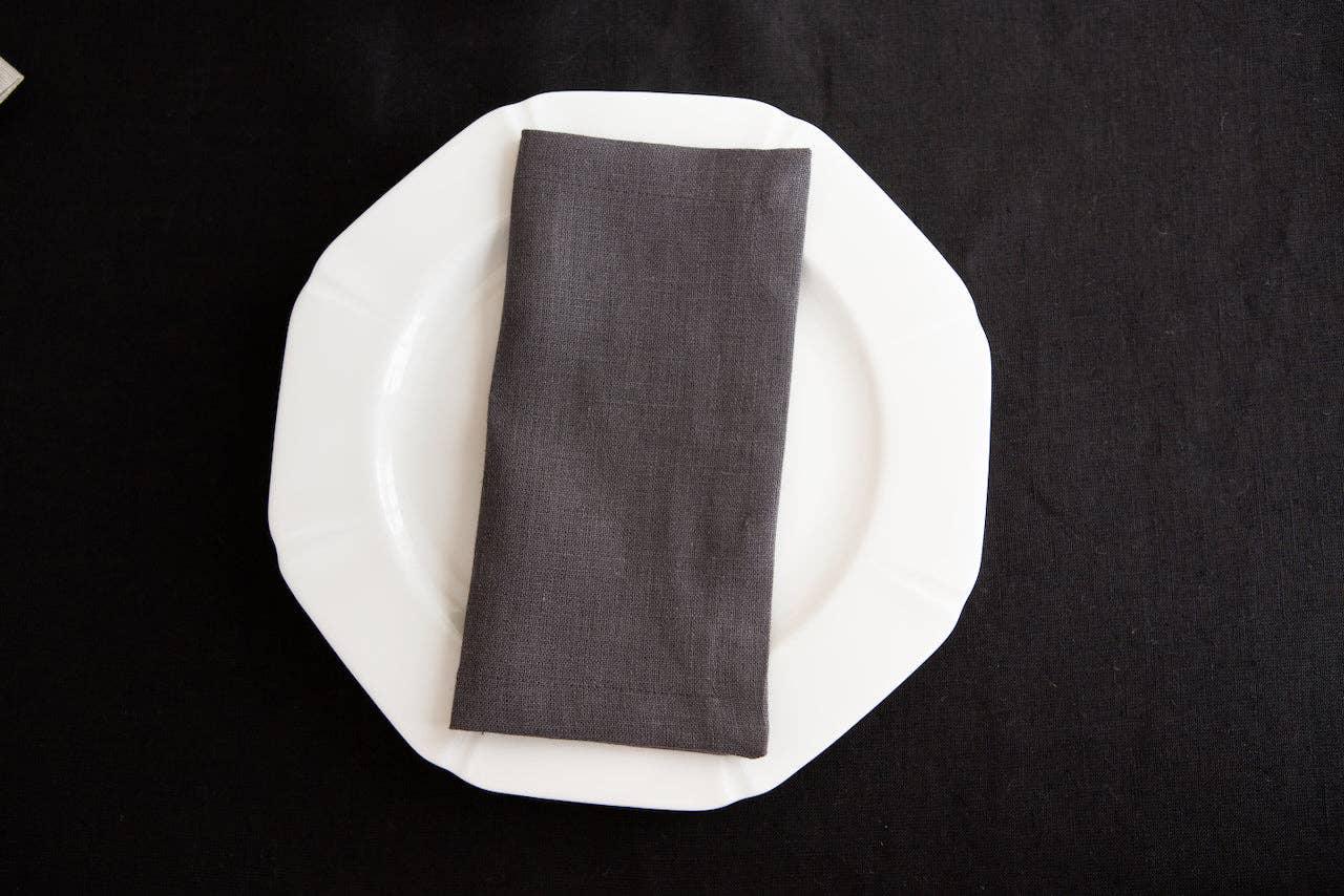 Maison Flaneur grey linen napkin on white ceramic plate, elegant table setting