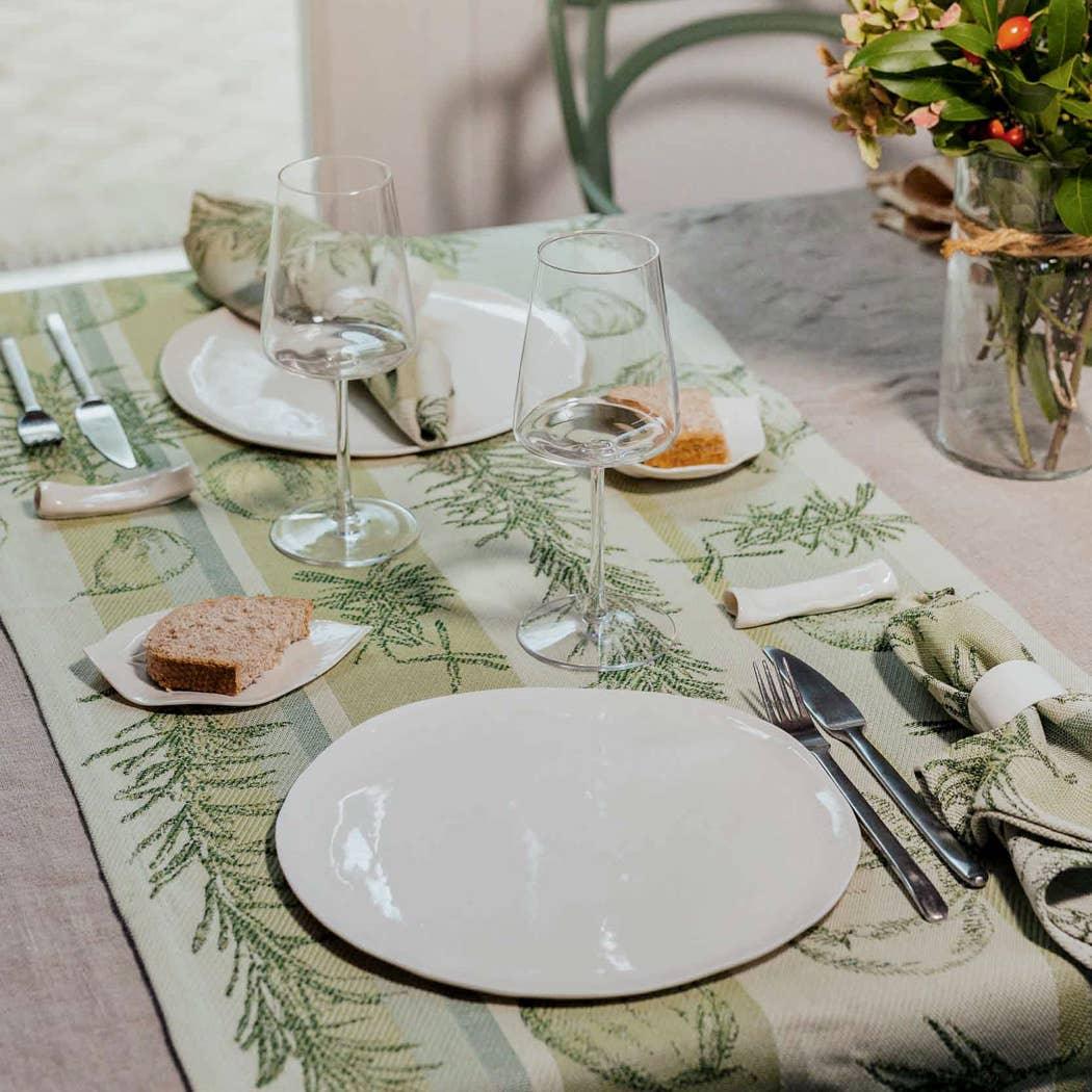 Tessitura Toscana Telerie botanical cotton table runner in green on elegant dining table