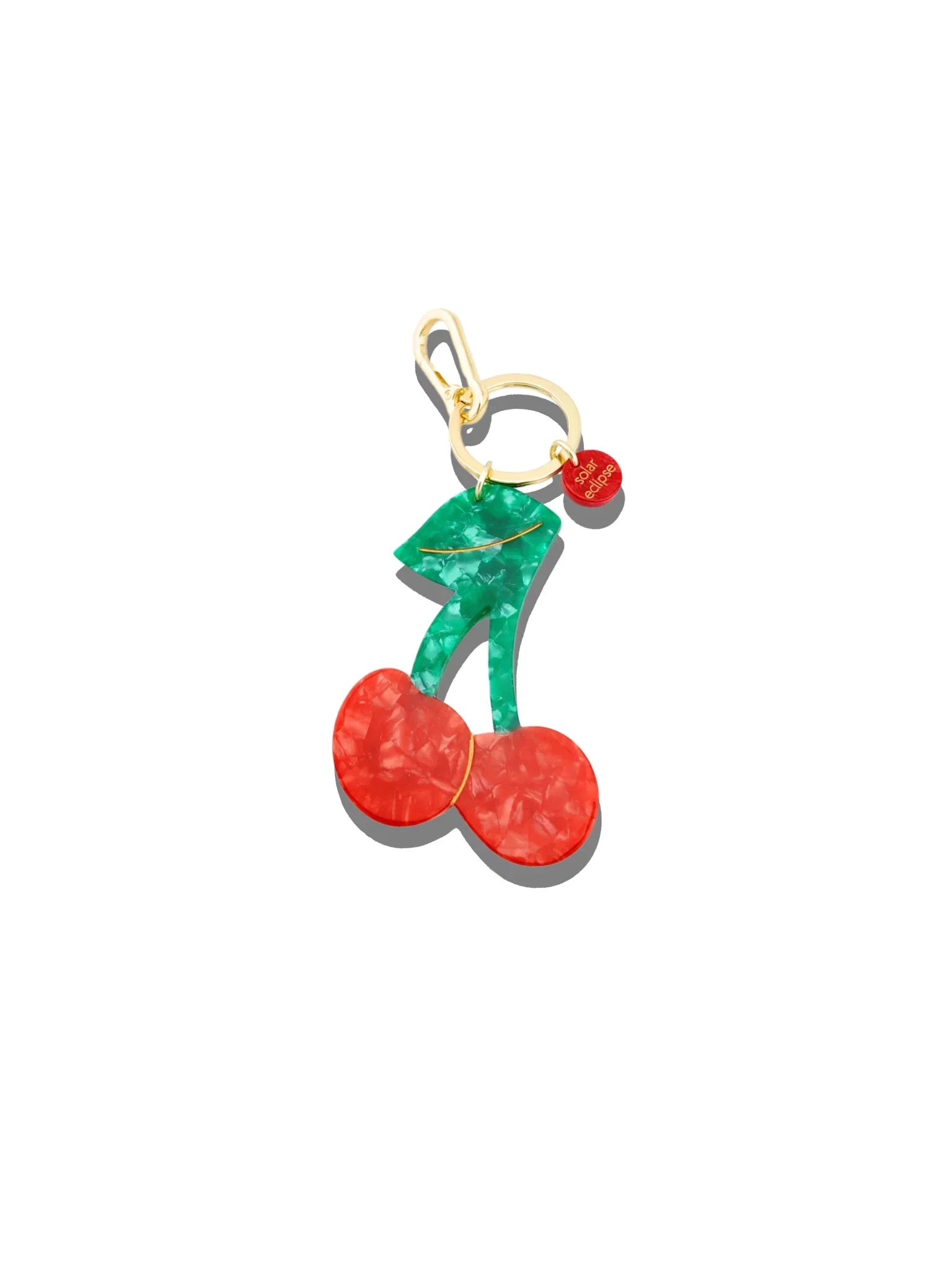 Solar Eclipse cherry-shaped keychain in marbled red and green acrylic with gold hardware