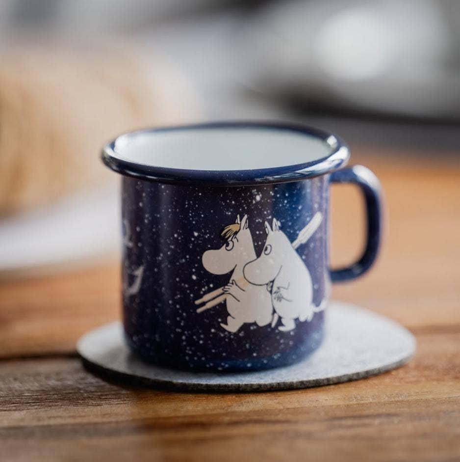 Moomin blue enamel mug with white character graphics, premium metal cup on coaster
