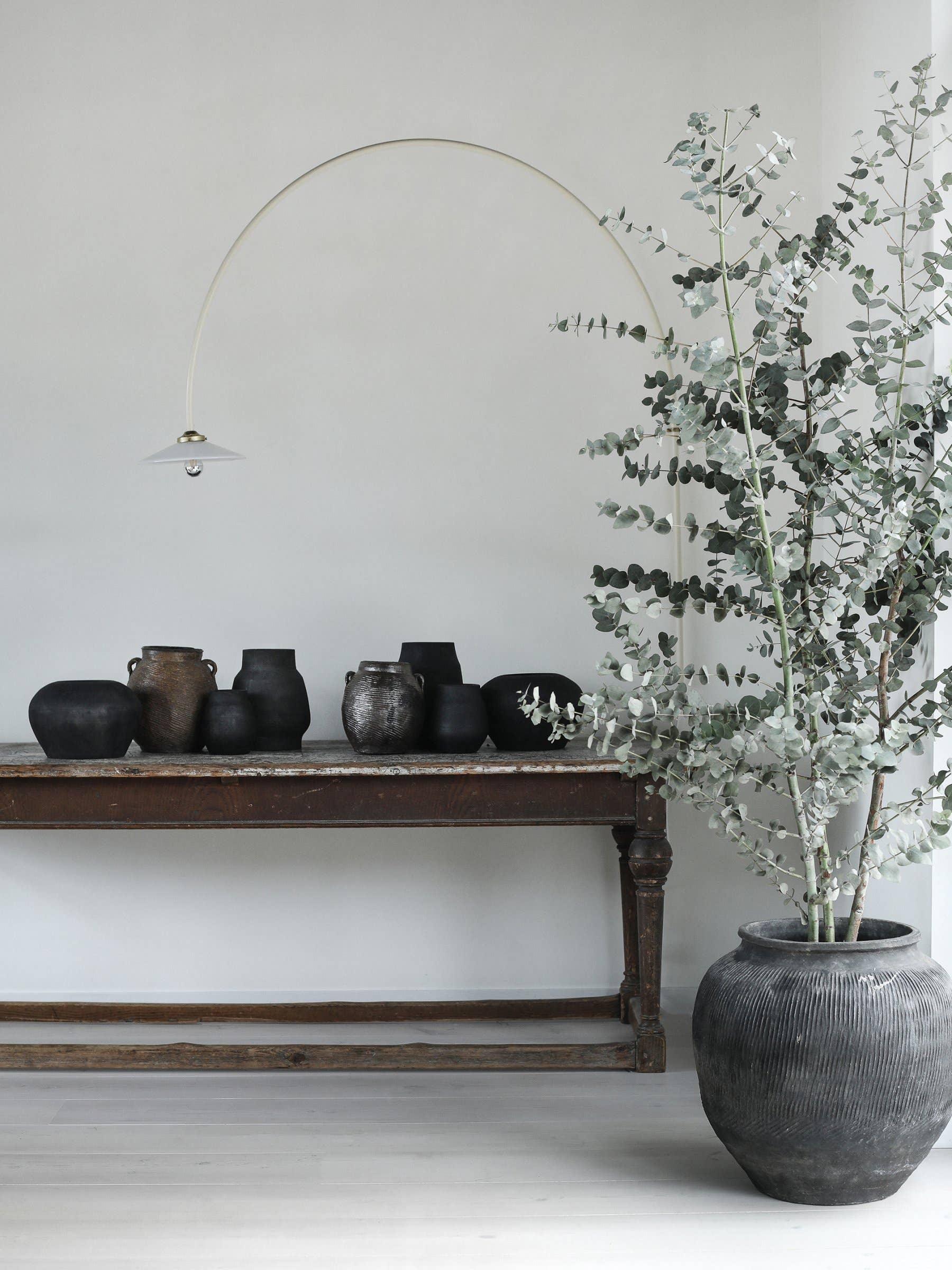 Viktoria Black ceramic vases on rustic wooden console, large grey planter with eucalyptus
