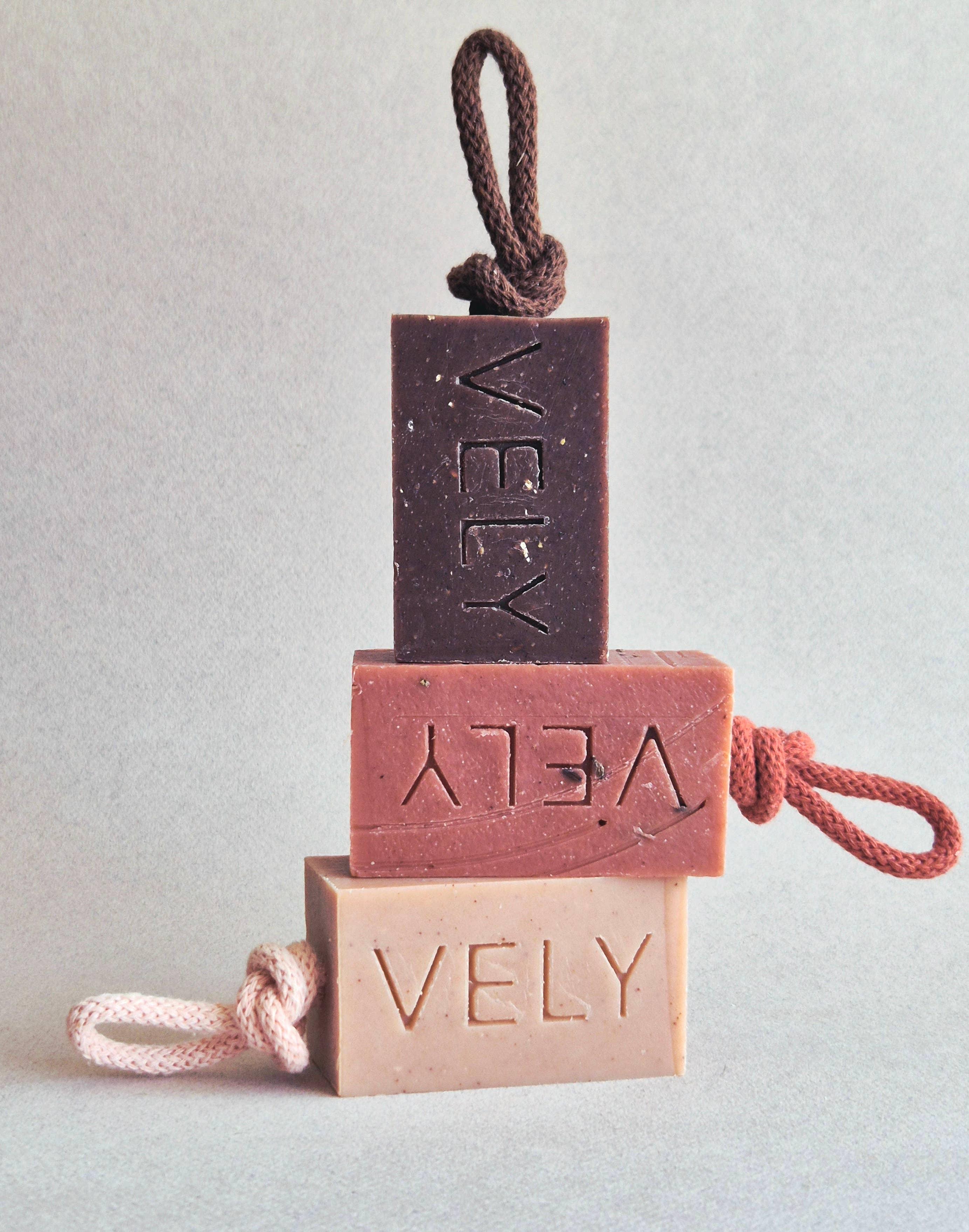 VELY handmade soap bars in brown, pink, and beige with cotton rope, minimalist display