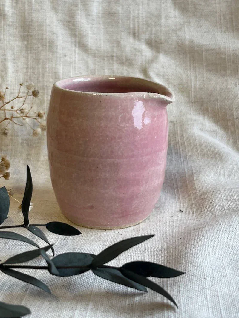 Handmade ceramic pink jug by Goldrick on linen fabric with botanical decor