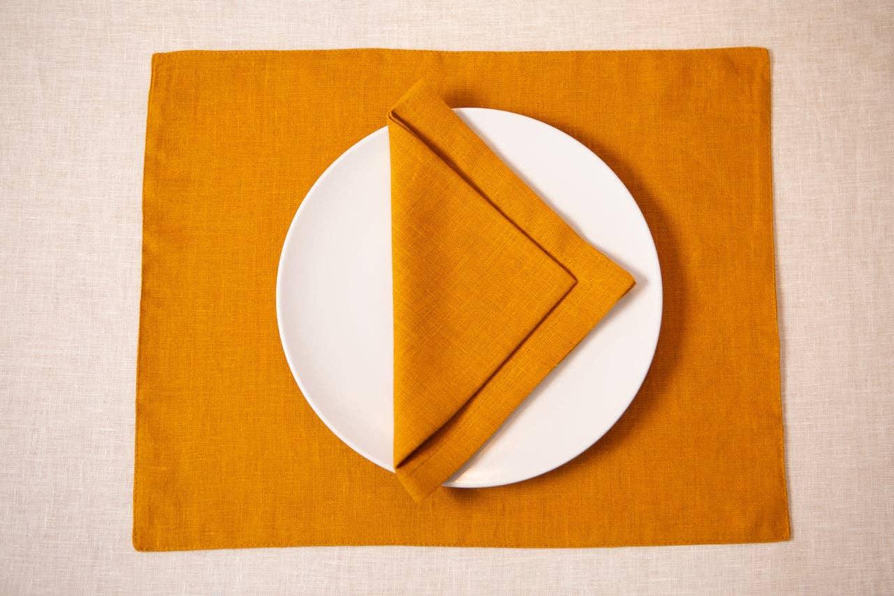 Maison Tess ochre linen placemat and napkin set with white ceramic plate