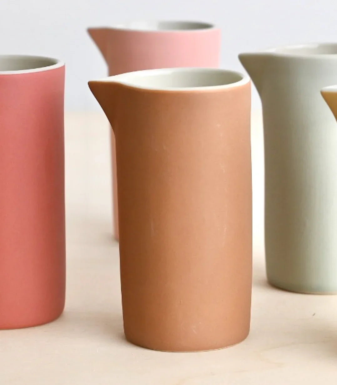 Hasami Porcelain ceramic pitcher in matte pastel pink, peach and cream tones