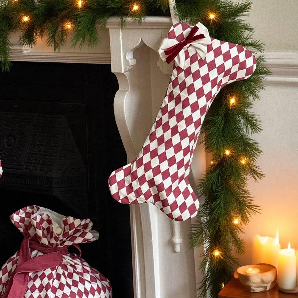 Casa Cubista dog bone stocking, red and white cotton, hanging on mantel with Christmas decor