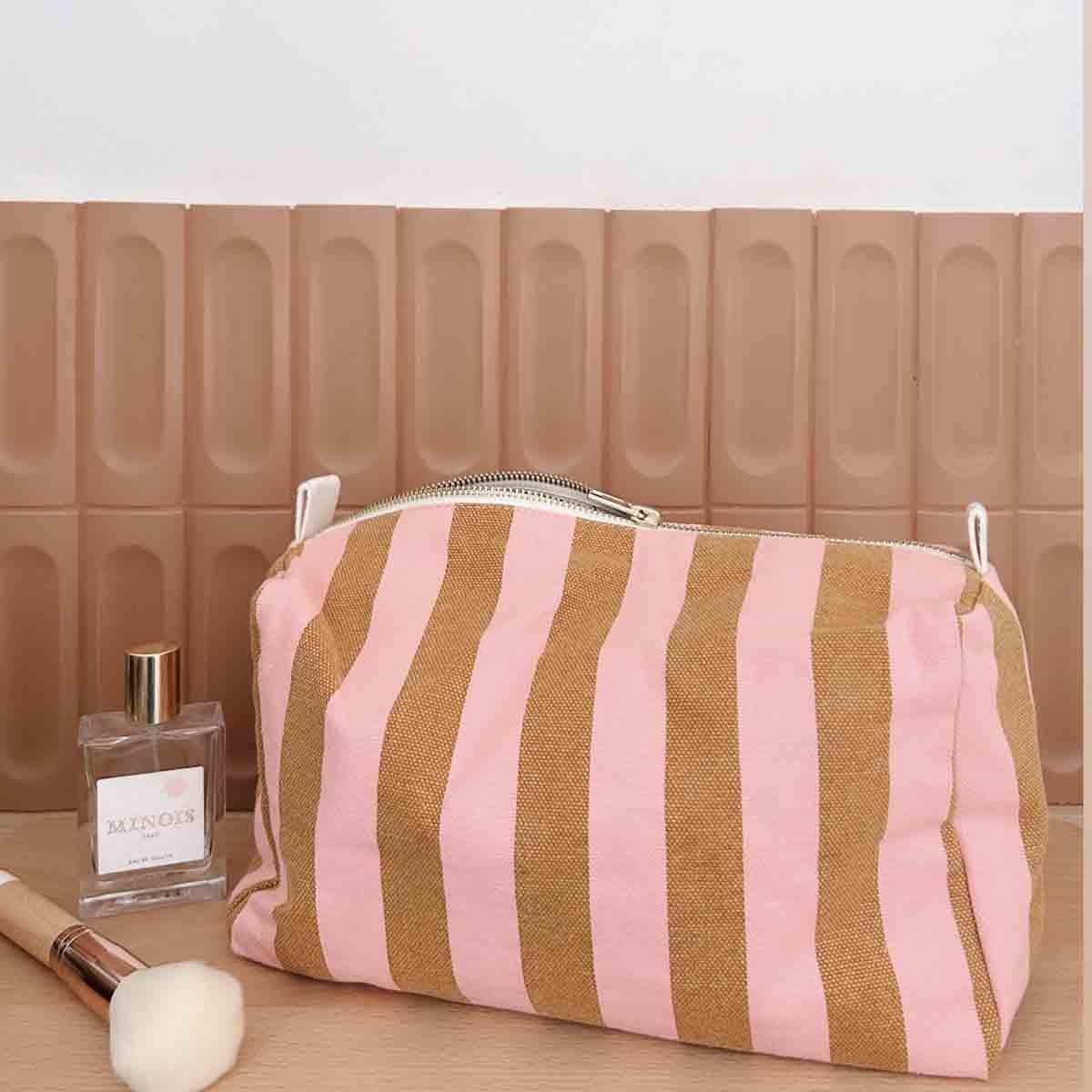MINOIS striped cotton canvas makeup bag in pink and brown with perfume and brush