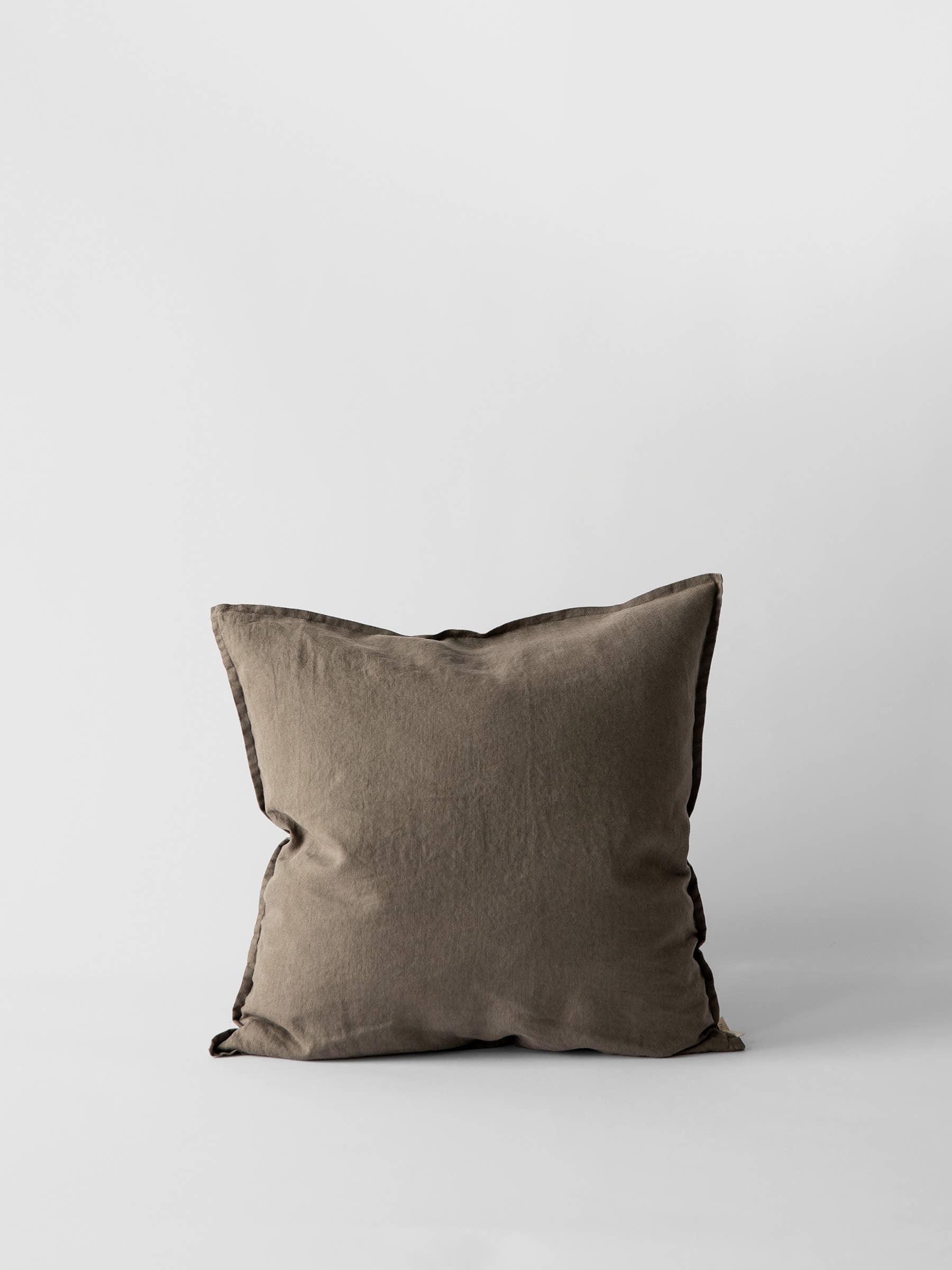 NODI dark brown linen cushion on white background, premium minimalist home decor pillow