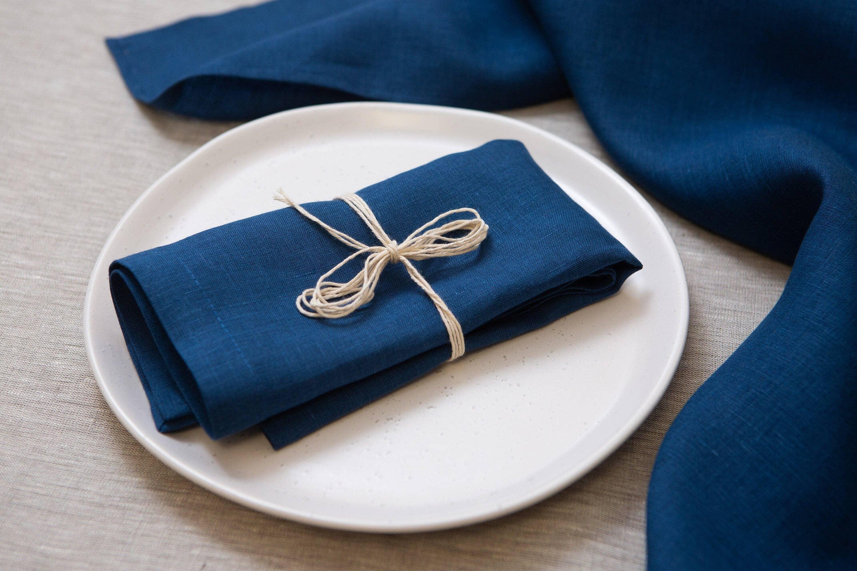 Linen Tales blue linen napkin on white plate, tied with string, elegant table setting