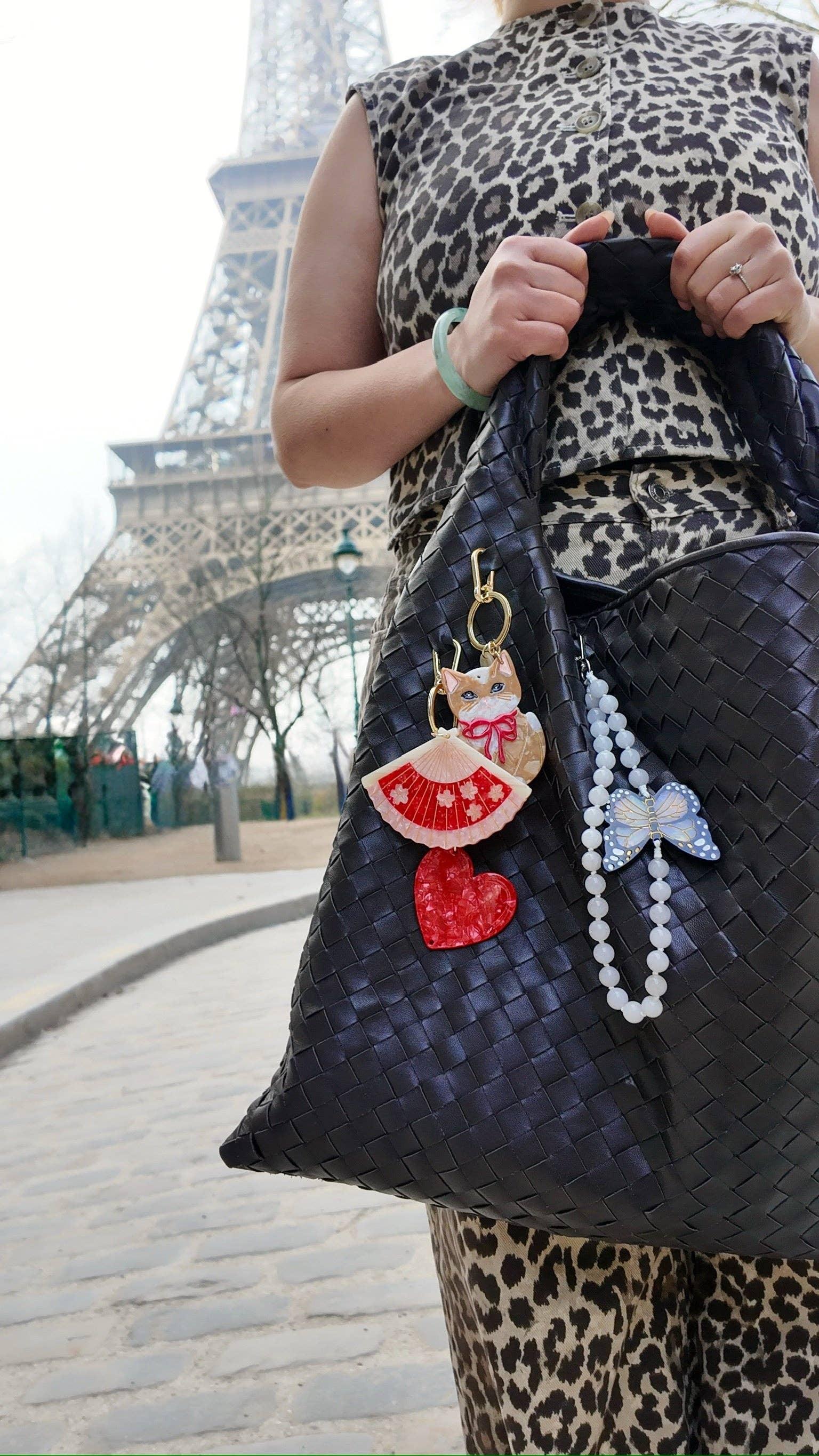 Vanina woven black handbag with acrylic charms, leopard print outfit, Eiffel Tower background
