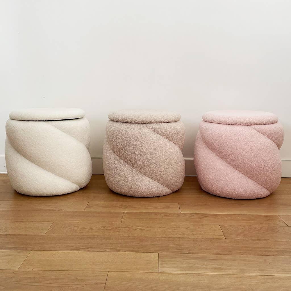 Sunday Citizen boucle ottomans in cream, beige, and blush pink on wood floor
