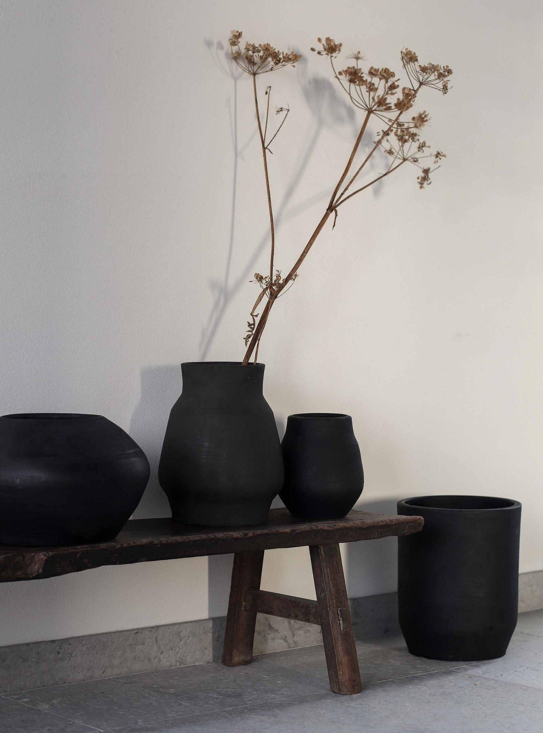 Baba Tree black clay vases on rustic wooden bench, minimalist decor, premium ceramics