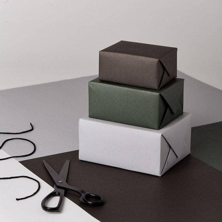 Minimalist premium gift boxes by Midori, black, green, and white paper, on elegant background