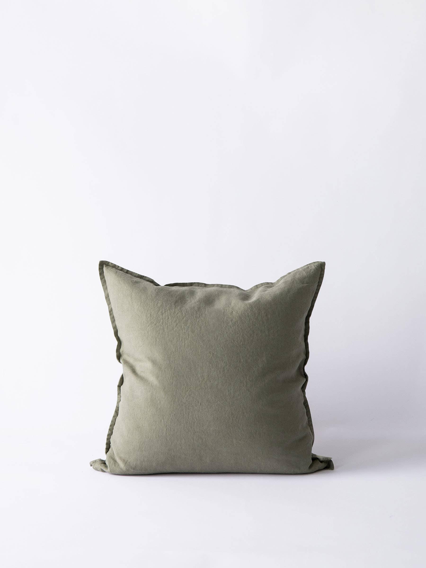 Humble Abode olive green linen throw pillow with flange detail on white background