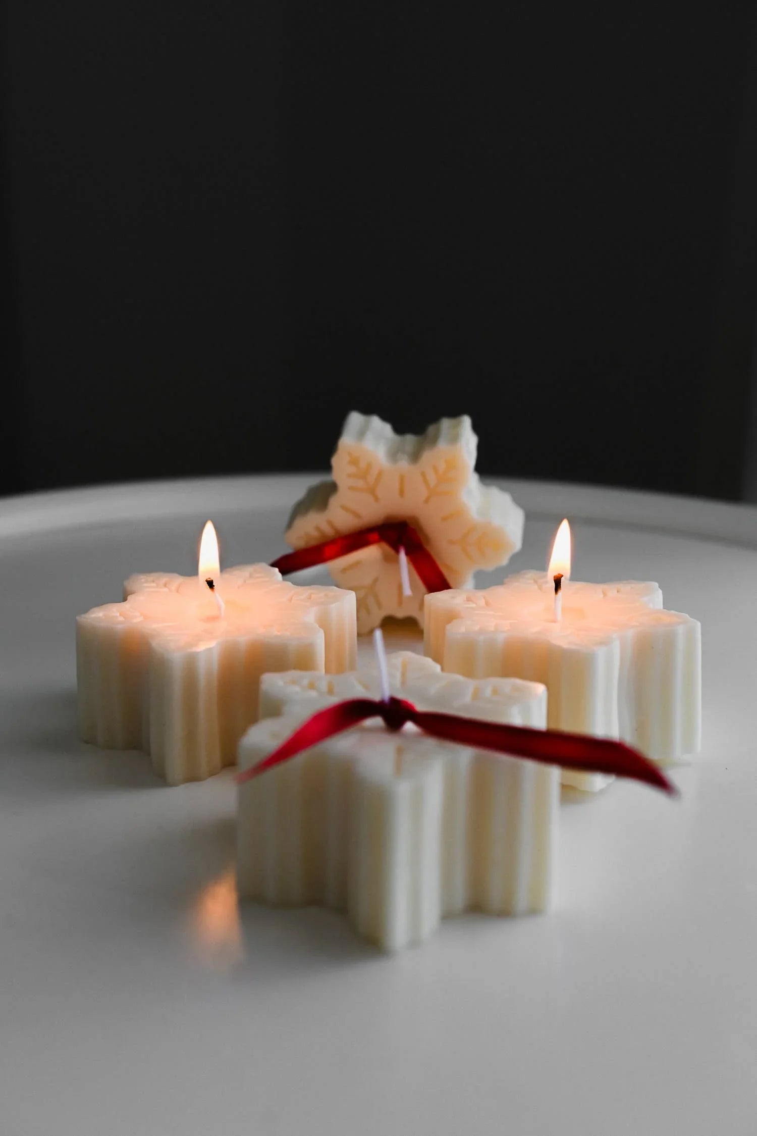 Snowflake Candles white soy wax, red ribbon, premium holiday decor on white surface