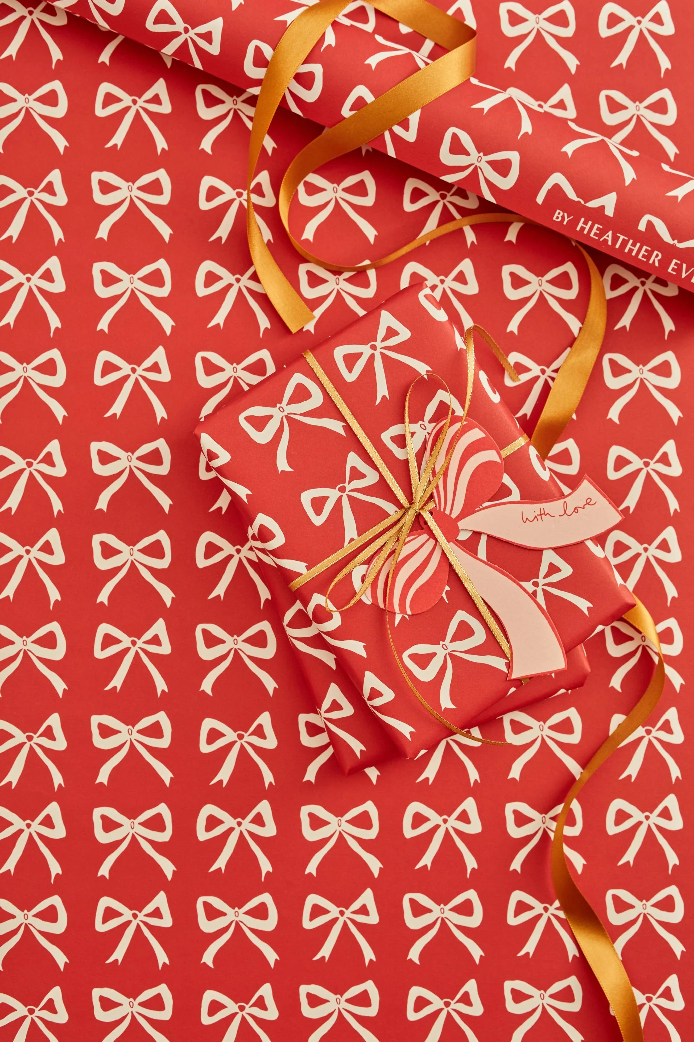 Heather Evans premium red wrapping paper with white bow pattern and gold ribbon