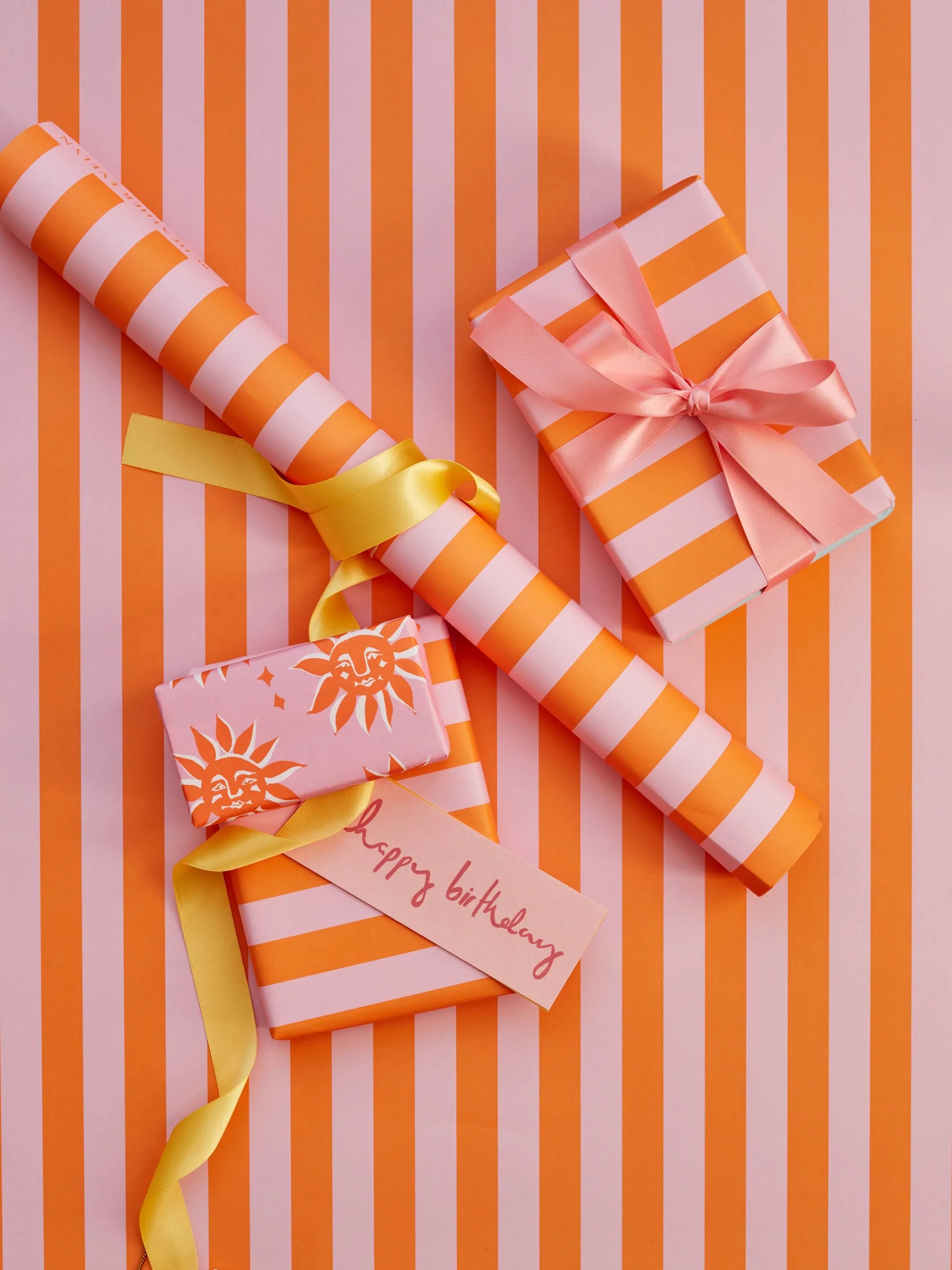 Blushing Confetti striped wrapping paper and gifts in orange and pink premium paper, satin ribbons