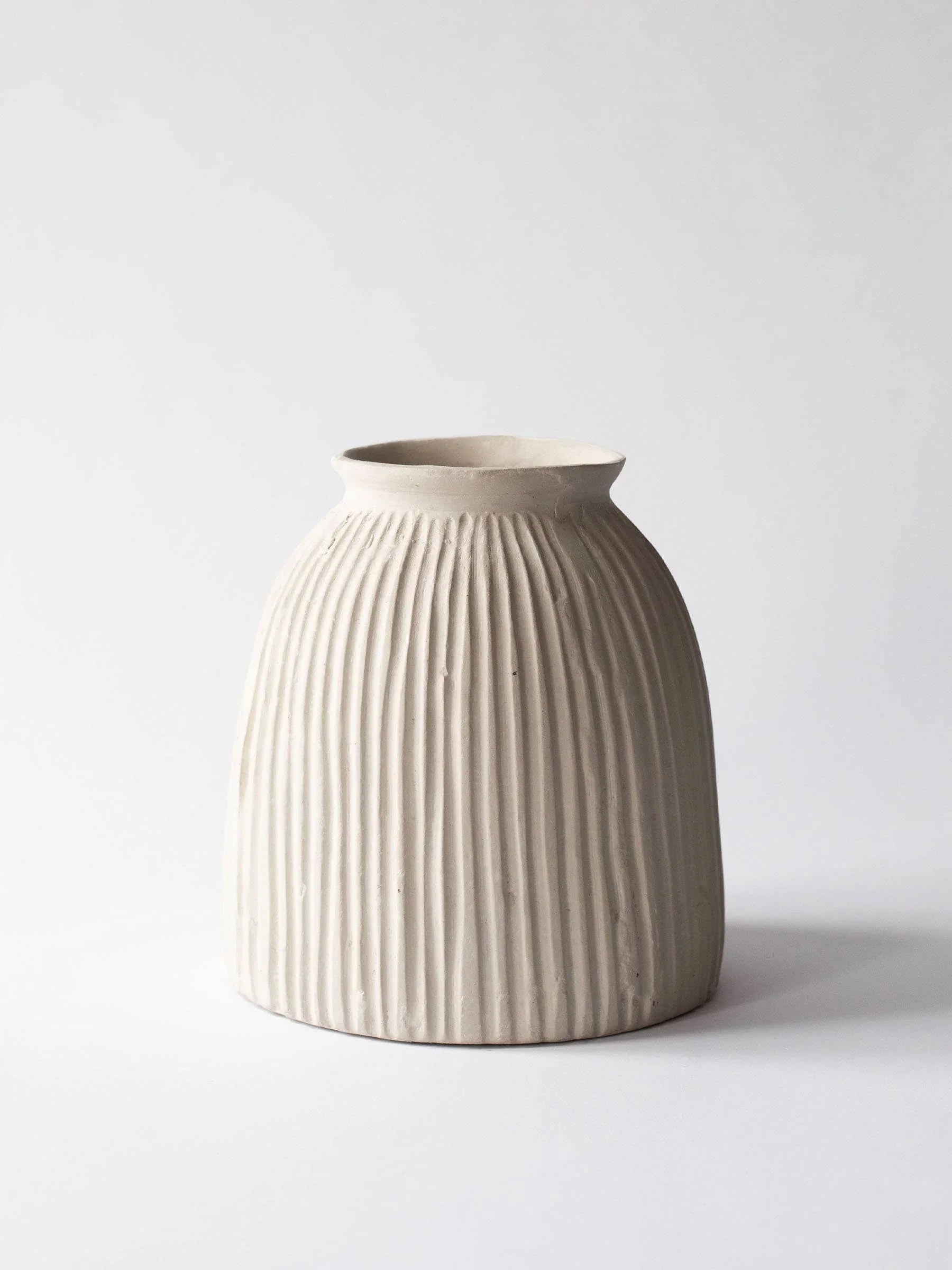 Plain and Simple ceramic ribbed beige vase on white background.