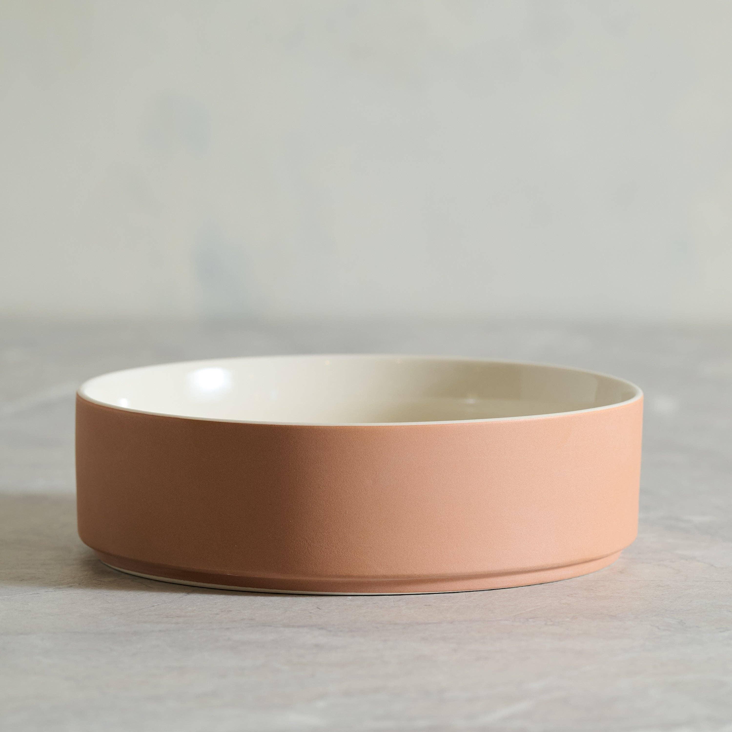 Rigby ceramic bowl in matte terracotta and cream stoneware on a neutral surface