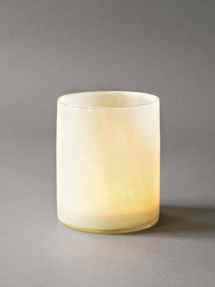 Skultuna ivory glass tealight holder with a smooth premium finish on a grey background