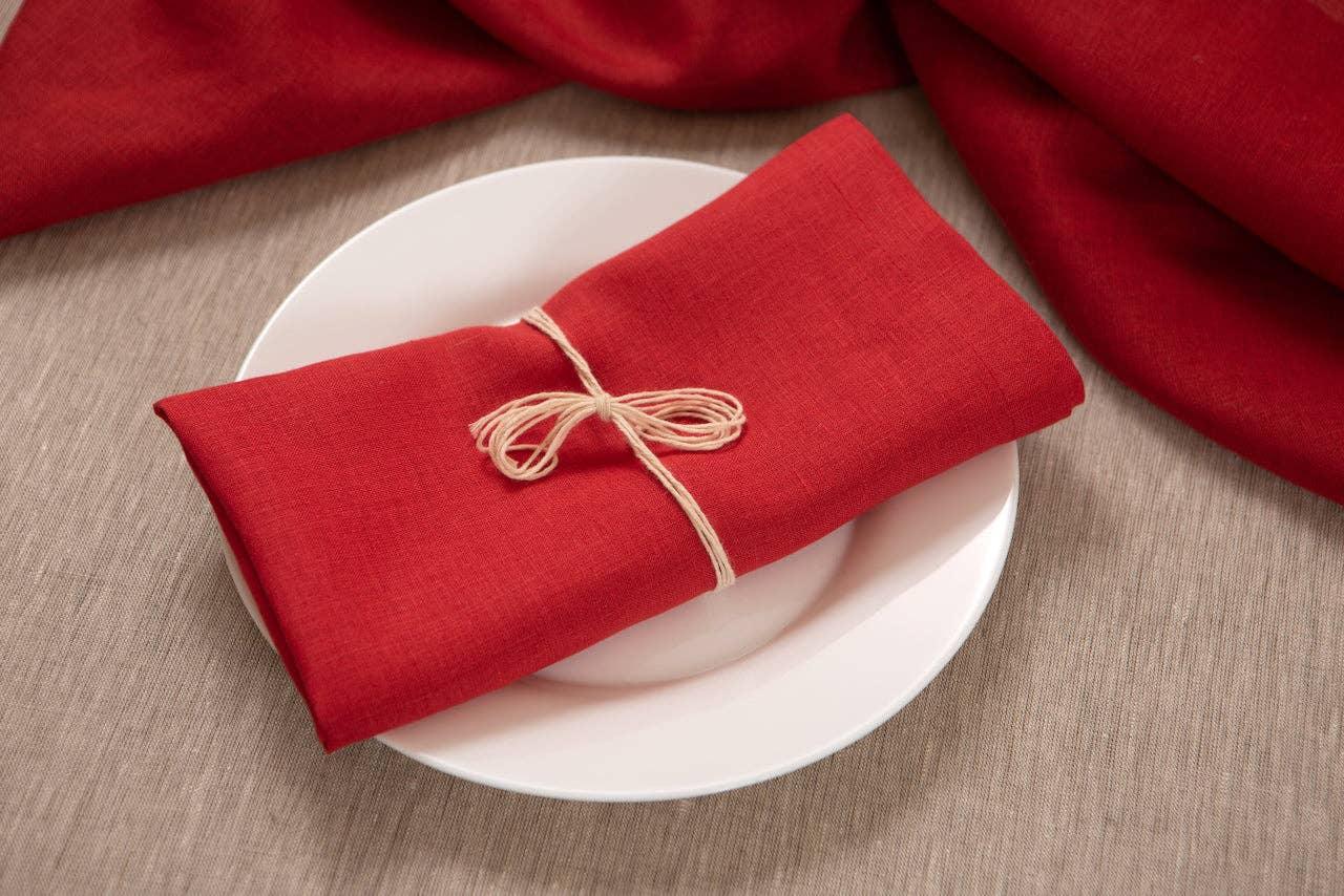 LinenDuet red linen napkin tied with string on white plate, premium table setting