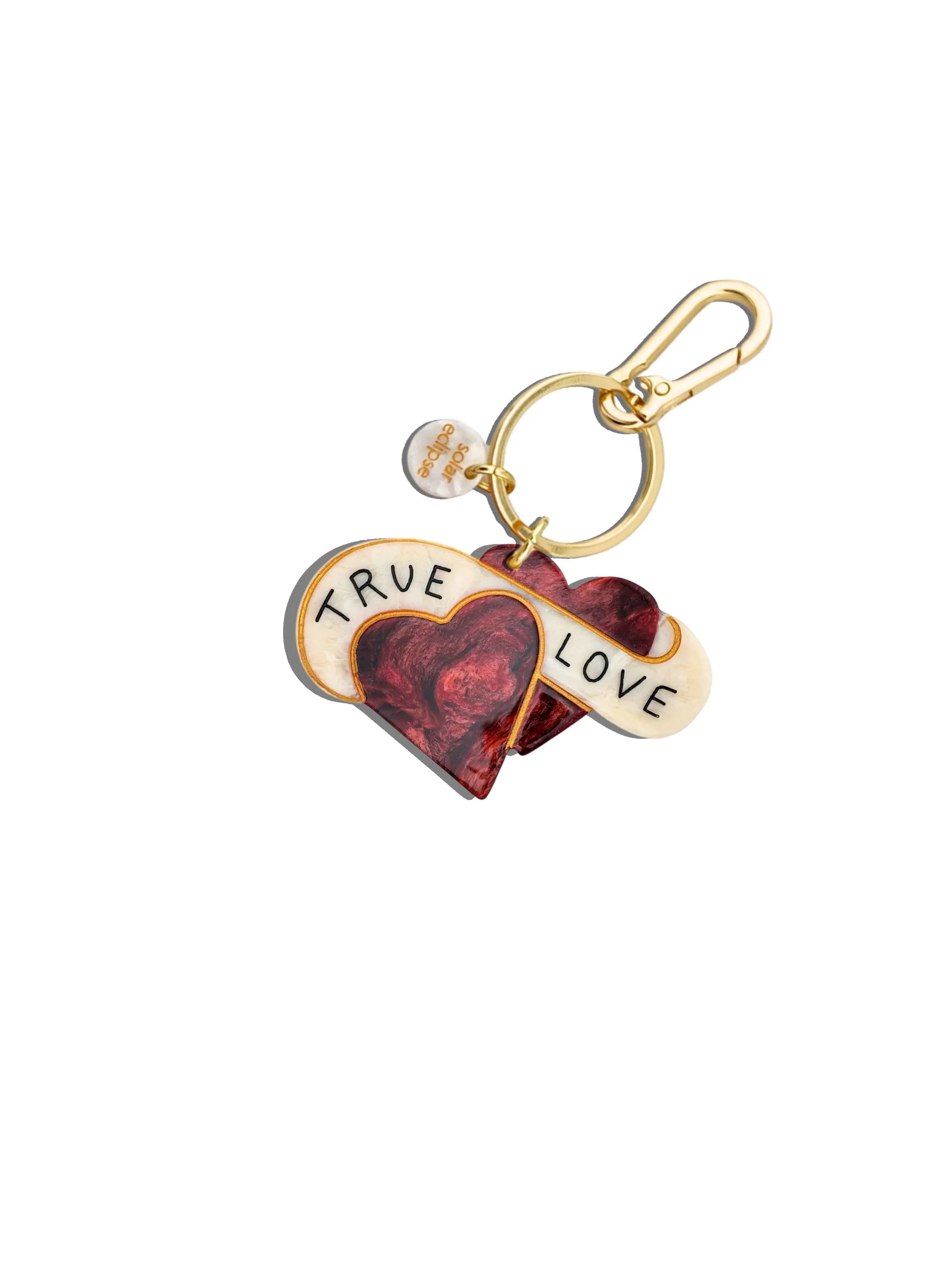 Sole Coupe keychain with gold hardware, red and cream resin heart design, 'TRUE LOVE' text