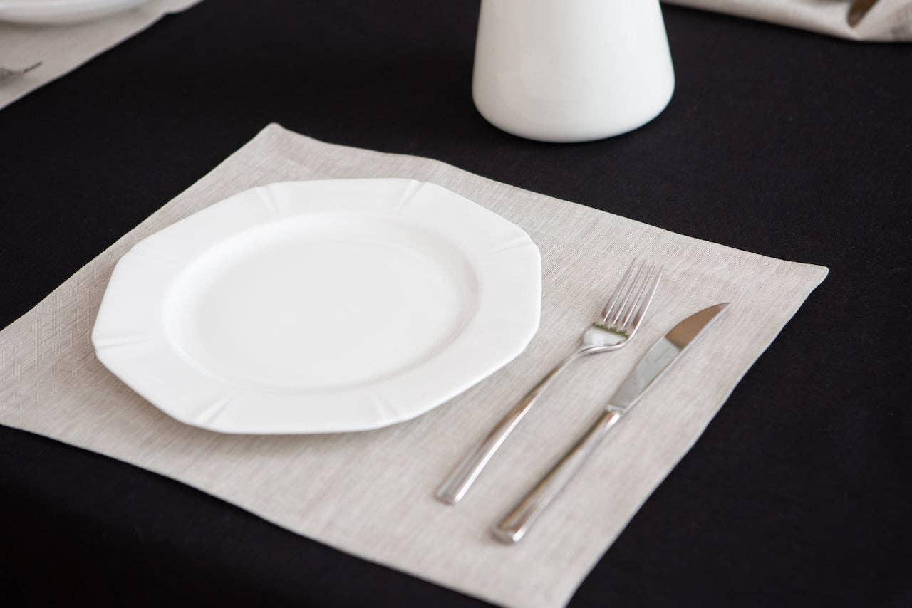 YUVAL Home linen placemat in beige with white ceramic plate and stainless steel cutlery