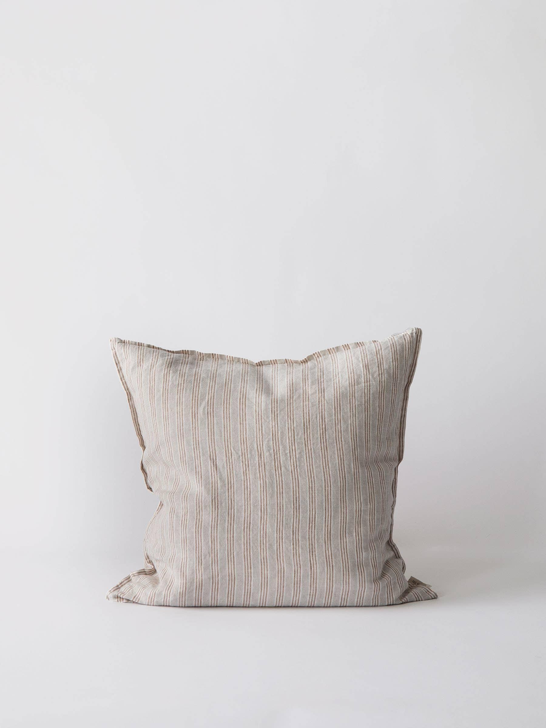 Tensira striped linen cushion in beige and brown on white background