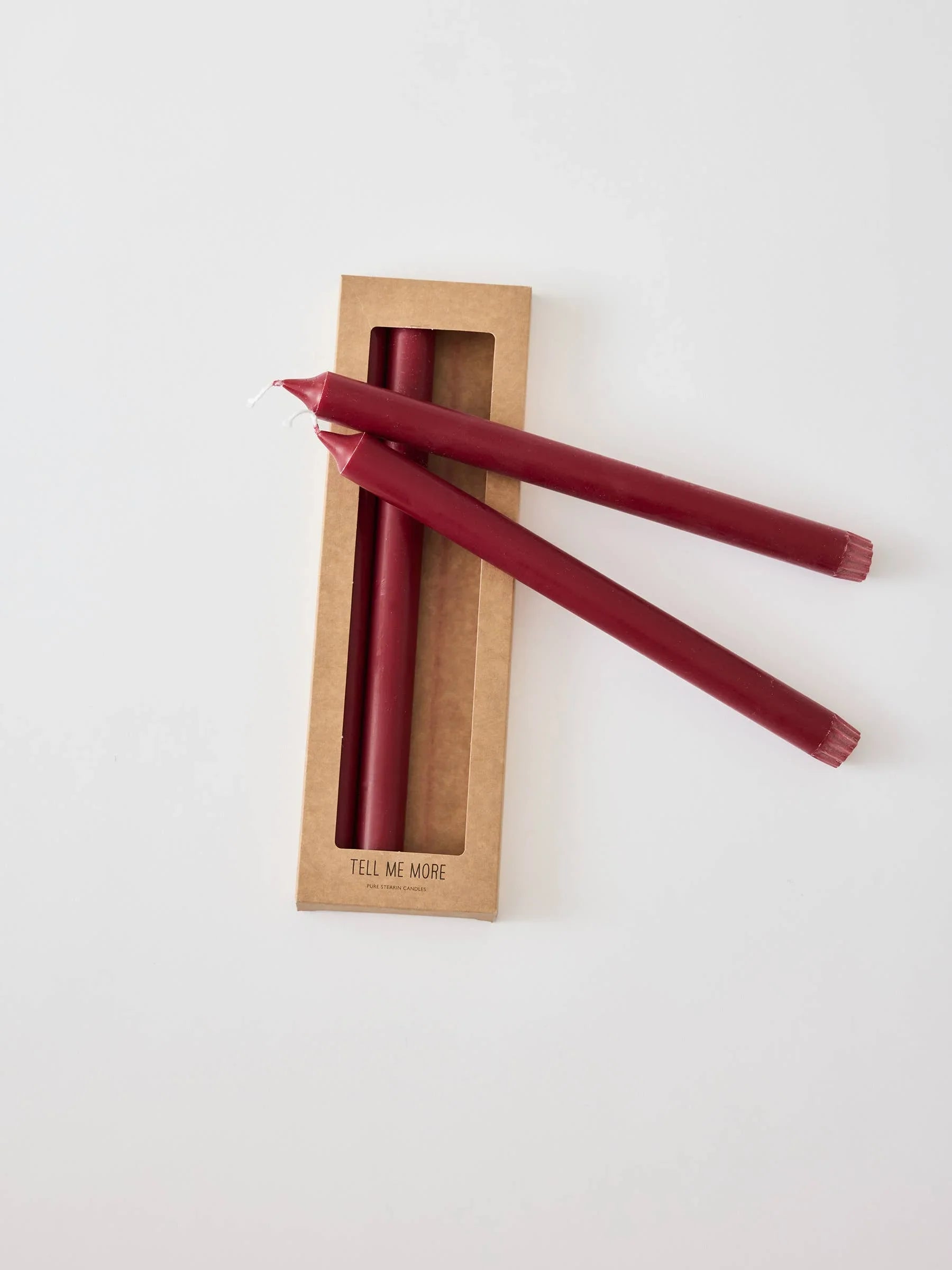 Tell Me More burgundy wax taper candles in kraft box on white background
