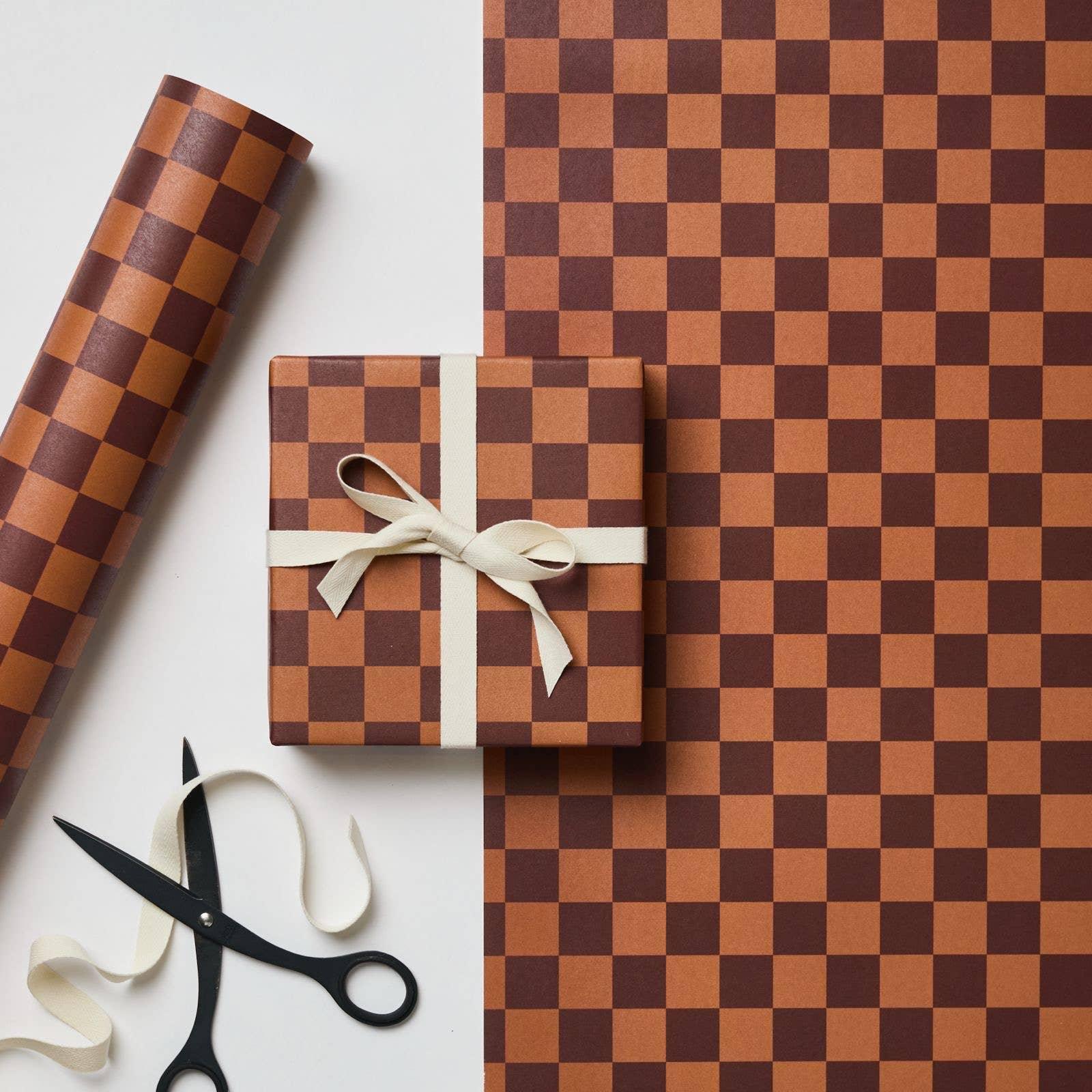 Wrap magazine brown checkerboard wrapping paper and ribbon with gift box on white background