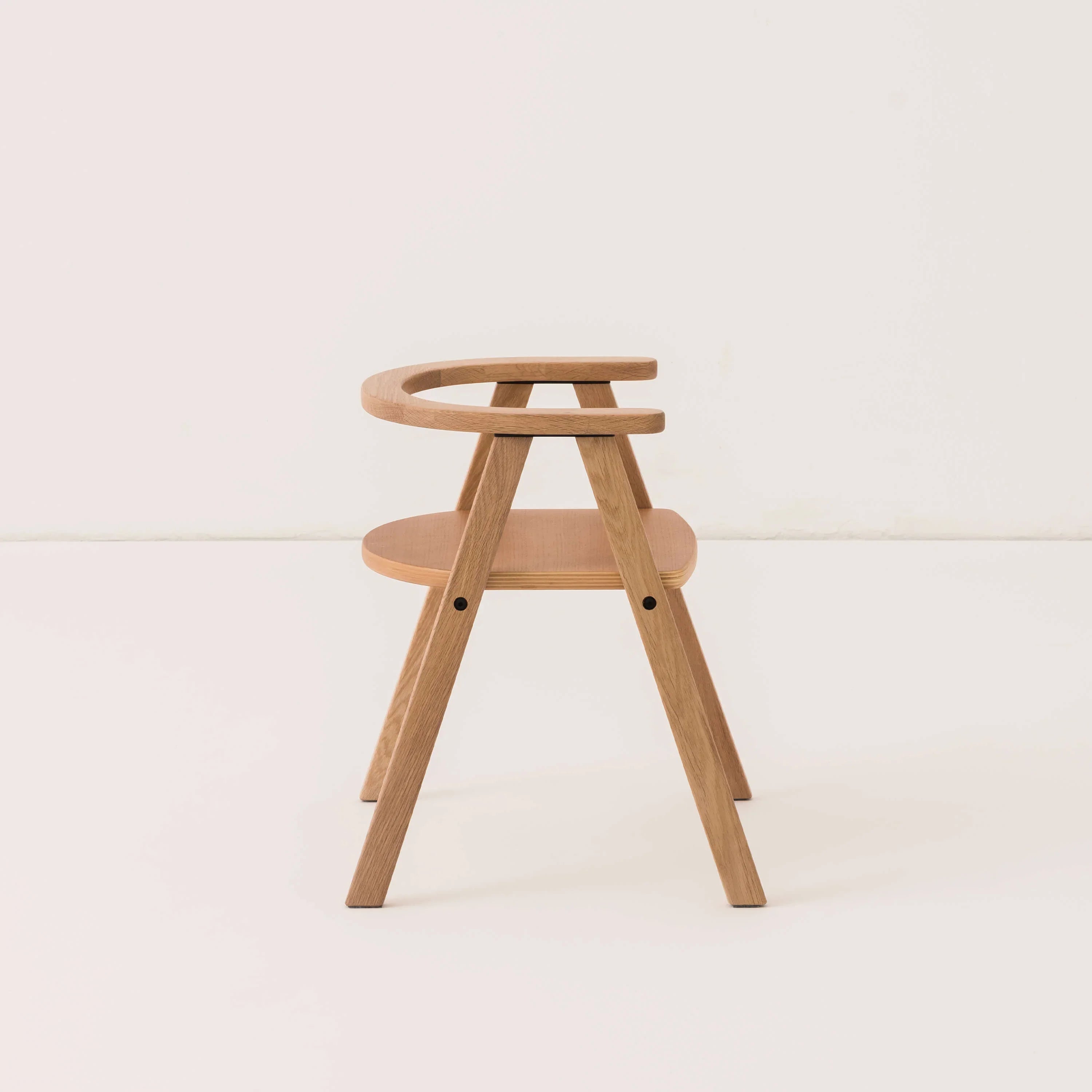 Nobodinoz Growing Green kid chair in natural oak wood, minimalist design on white background