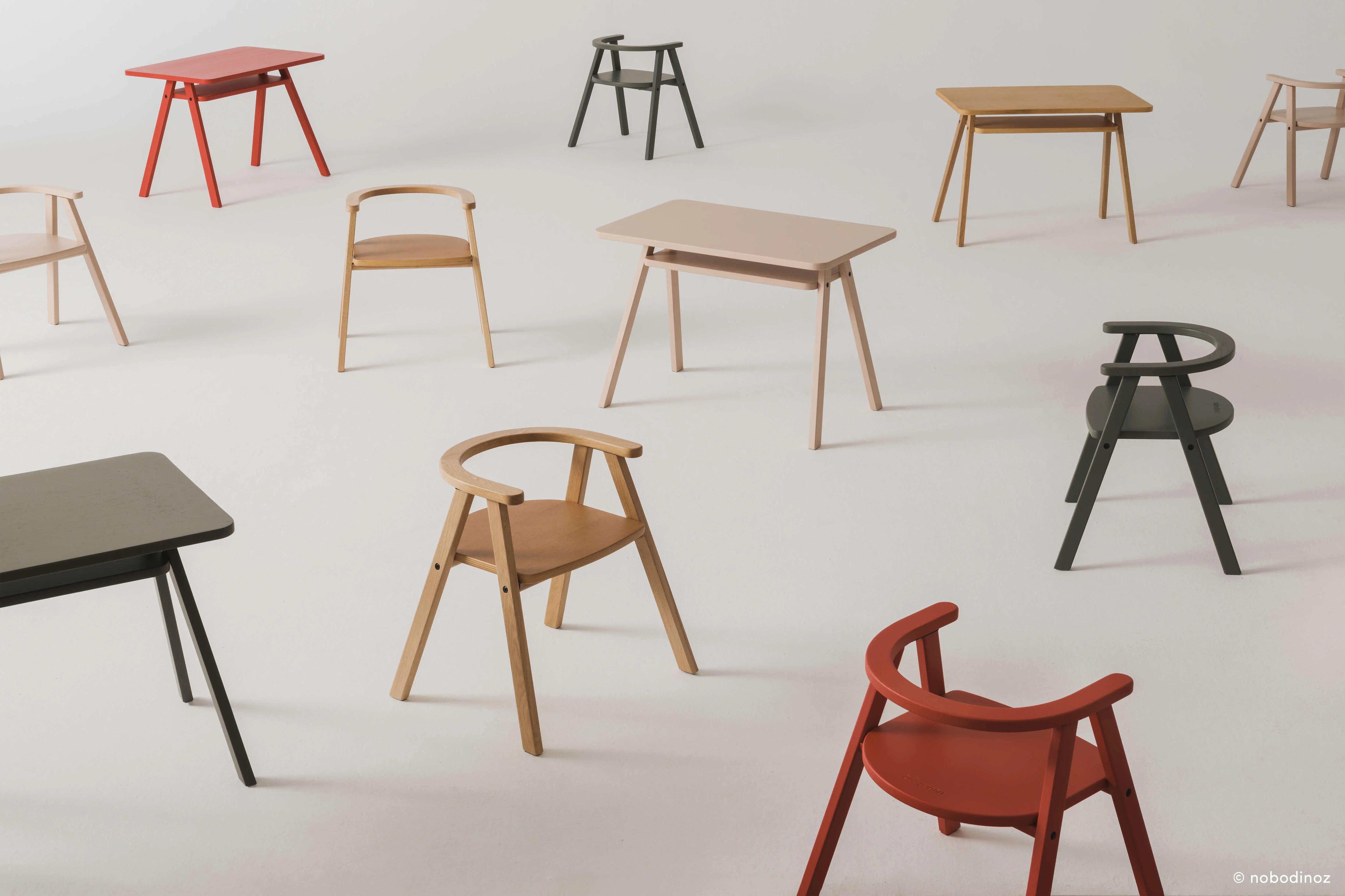 Nobodinoz Growing Green kid tables and chairs in natural oak and colorful finishes on white background.